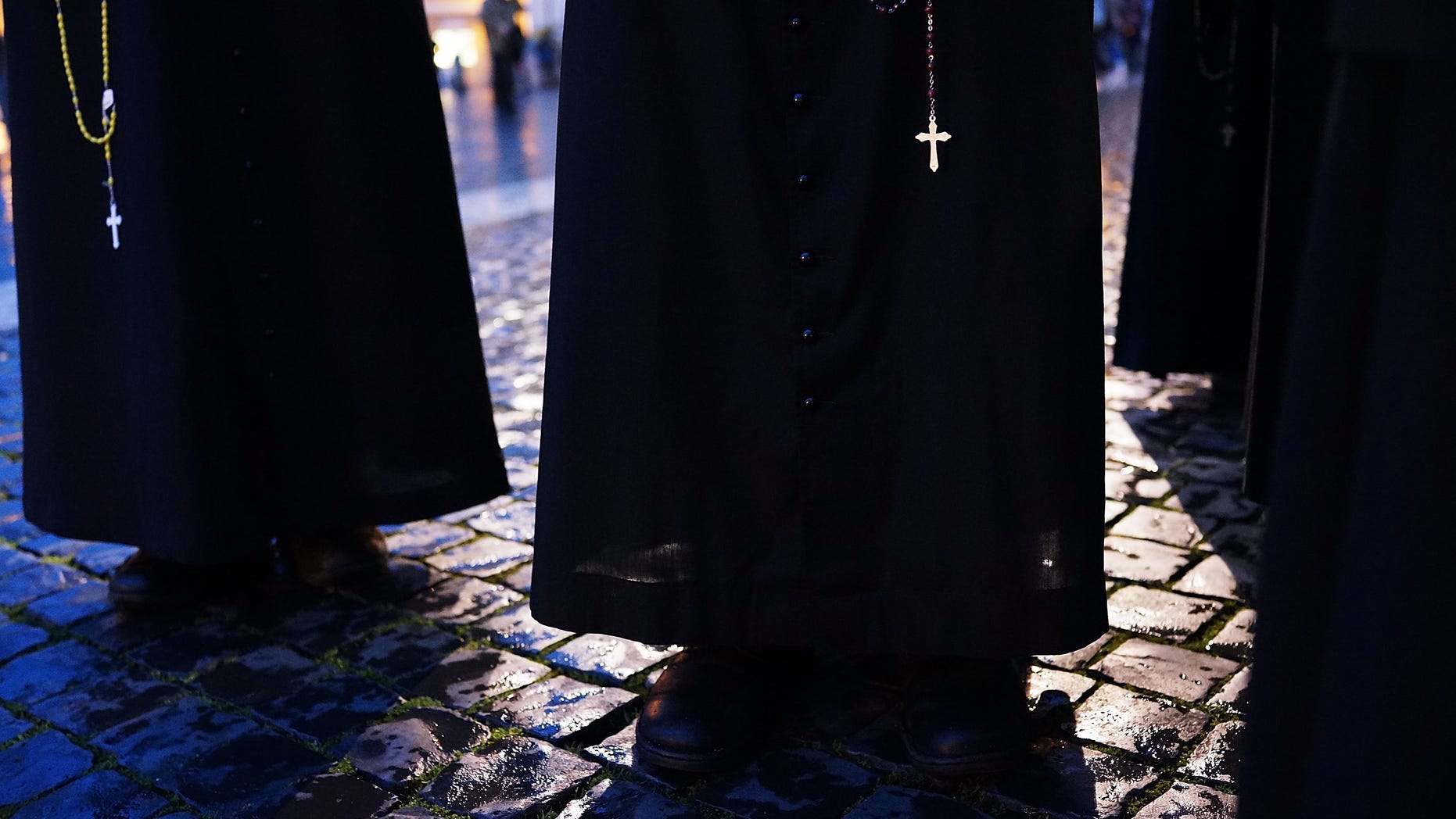 VATICAN CITY, VATICAN - MARCH 12: A group of priests wait for a sign of smoke in St. Peter's Square on March 12, 2013 in Vatican City, Vatican. Pope Benedict XVI's successor is being chosen by the College of Cardinals in Conclave in the Sistine Chapel. The 115 cardinal-electors, meeting in strict secrecy, will need to reach a two-thirds-plus-one vote majority to elect the 266th Pontiff. (Photo by Spencer Platt/Getty Images)