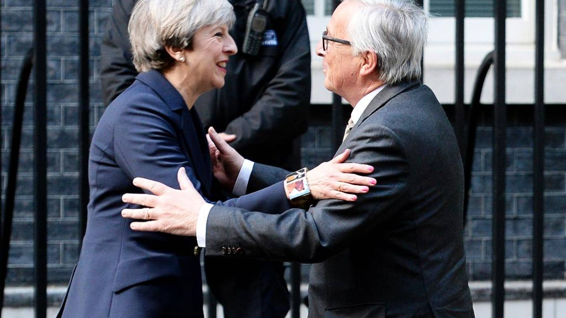 FILE - In this April 4, 2017 file photo, Britain's Prime Minister Theresa May greets European Commission President Jean-Claude Juncker outside 10 Downing Street in London. Theresa May acknowledged Tuesday May 2, 2017 that Brexit "will not be easy," after EU officials accused Britain of underestimating the complexity of the task ahead. (John Stillwell/PA via AP)