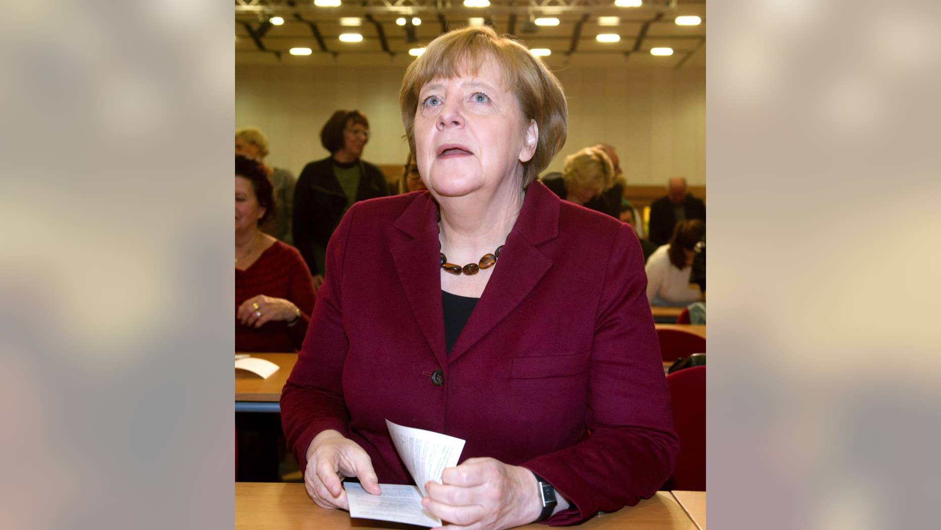 German Chancellor Angela Merkel attends a local meeting of her Christian Democrats, CDU, in Grimmen, northern Germany, Saturday, Jan. 28, 2017. Merkel said there's no solution yet to the problem of how to fairly share the burden of migration among European Union member states. (Stefan Sauer/dpa via AP)