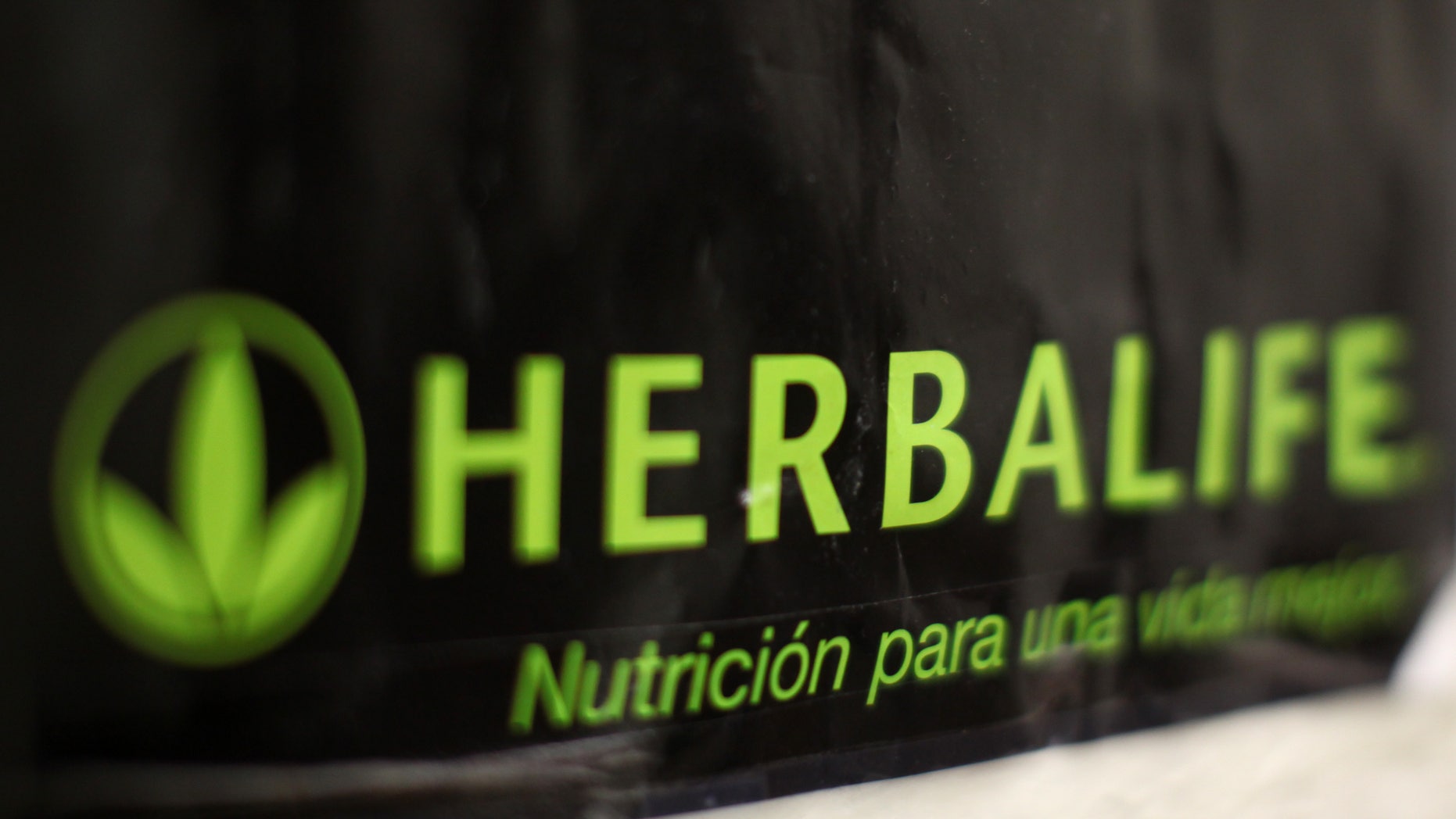 An Herbalife logo is shown on a poster at a clinic in the Mission District in San Francisco, California April 29, 2013. Herbalife Ltd posted surprisingly strong quarterly earnings and raised its full-year profit forecast on Monday, putting pressure on high-profile investor Bill Ackman, who is betting against the nutritional products company REUTERS/Robert Galbraith (UNITED STATES - Tags: SOCIETY BUSINESS) - RTXZ4KH