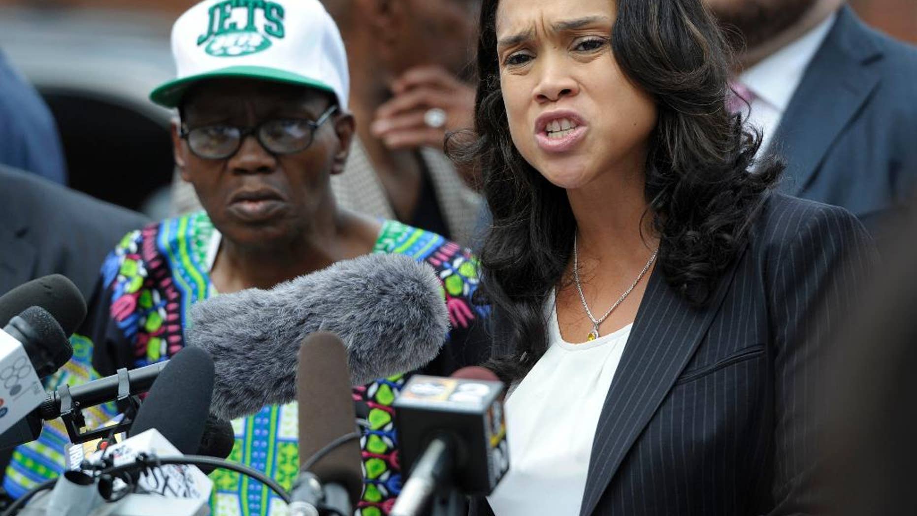 Baltimore State's Attorney Marilyn Mosby, right, holds a news conference near the site where Freddie Gray was arrested after her office dropped the remaining charges against three Baltimore police officers awaiting trial in Gray's death, in Baltimore, Wednesday, July 27, 2016.