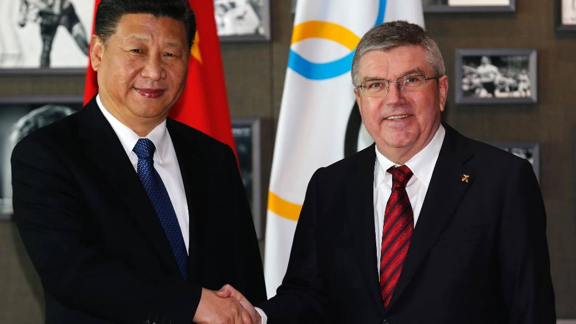 Chinese President Xi Jinping, left, shakes hand with International Olympic Committee, IOC, President Thomas Bach, right, before a meeting at the Olympic Museum in Lausanne, Switzerland, Wednesday, Jan. 18, 2017. (Denis Balibouse/Pool Photo via AP)