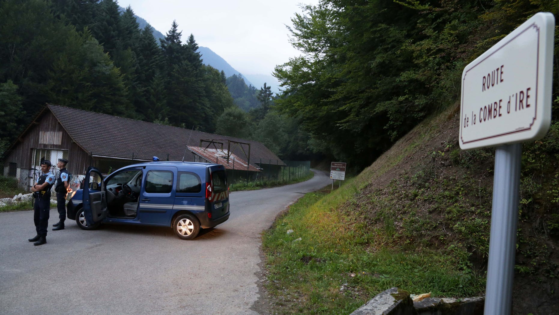 Sept. 5, 2012: Gendarmes block access to a killing site near Chevaline, French Alps. French authorities say at least four people have been shot to death in a forest in the Alps.An official with the regional administration for the Haute-Savoie region says three of the bodies were found in a BMW registered in Britain.