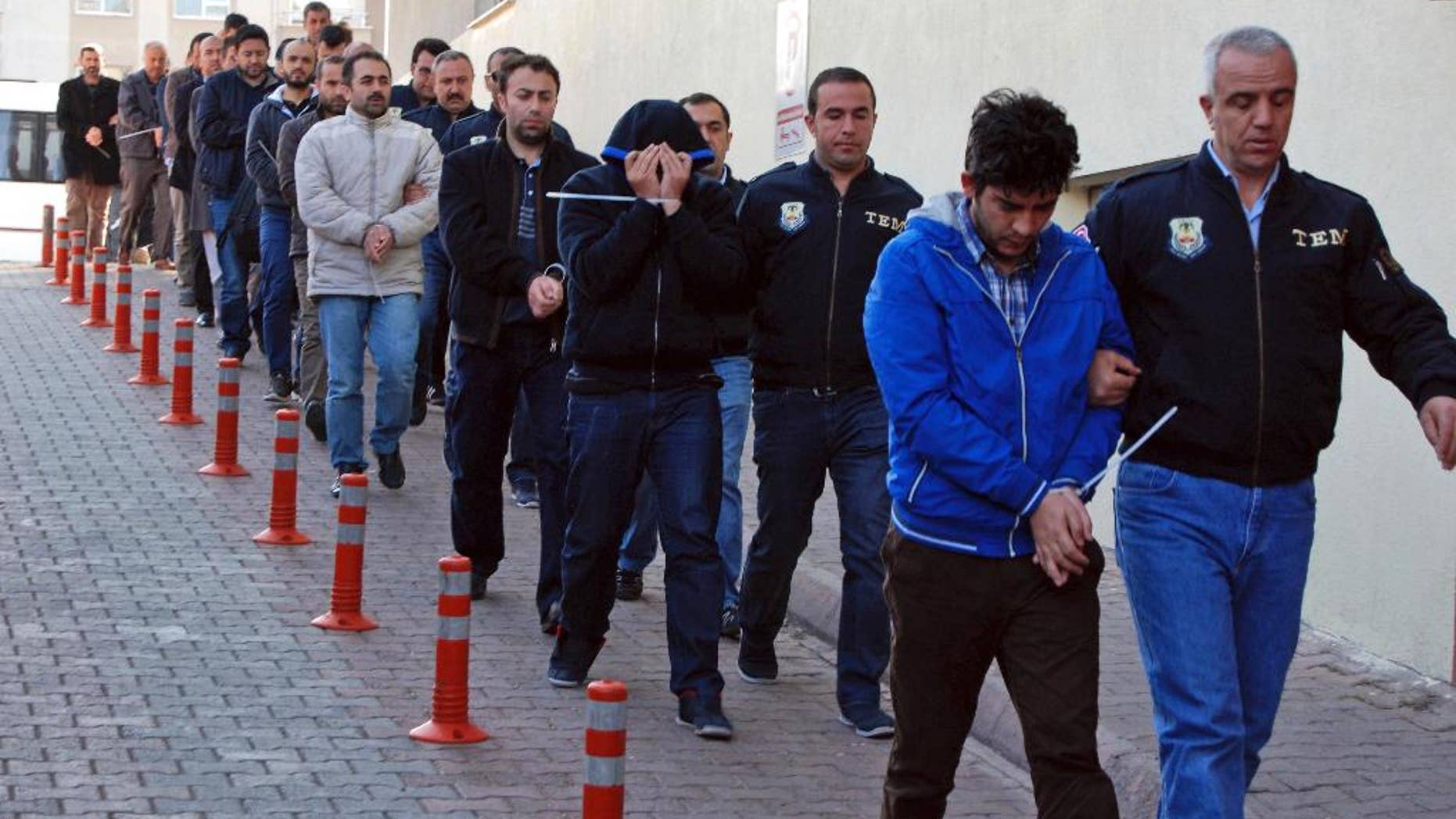 Police officers escort people, arrested because of suspected links to U.S.-based cleric Fethullah Gulen, in Kayseri, Turkey, Wednesday, April 26, 2017. Police launched simultaneous operations across the country on Wednesday, detaining hundreds of people with suspected links to U.S.-based cleric Fethullah Gulen. The suspects are allegedly Gulen operatives who directed followers within the police force. (Olay Duzgun/DHA-Depo Photos via AP)