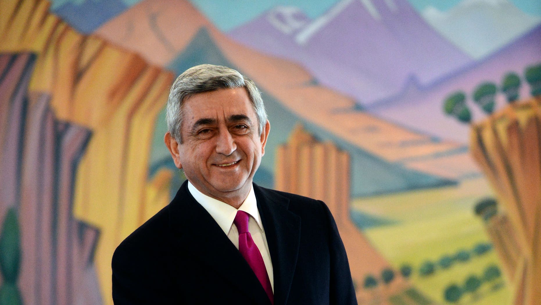 Armenian President Serge Sarkisian smiles as he casts his ballot during presidential election in Yerevan, Armenia Monday, Feb. 18, 2013. Armenian President Serge Sarkisian was re-elected for a second term in the first round of the ex-Soviet nation's presidential election, according to an exit poll Monday.The poll of 19,130 voters conducted by Gallup International and carried by ArmNews TV showed Sarkisian winning 58 percent of Monday's ballot. (AP Photo/PanARMENIAN Tigran Mehrabyan)