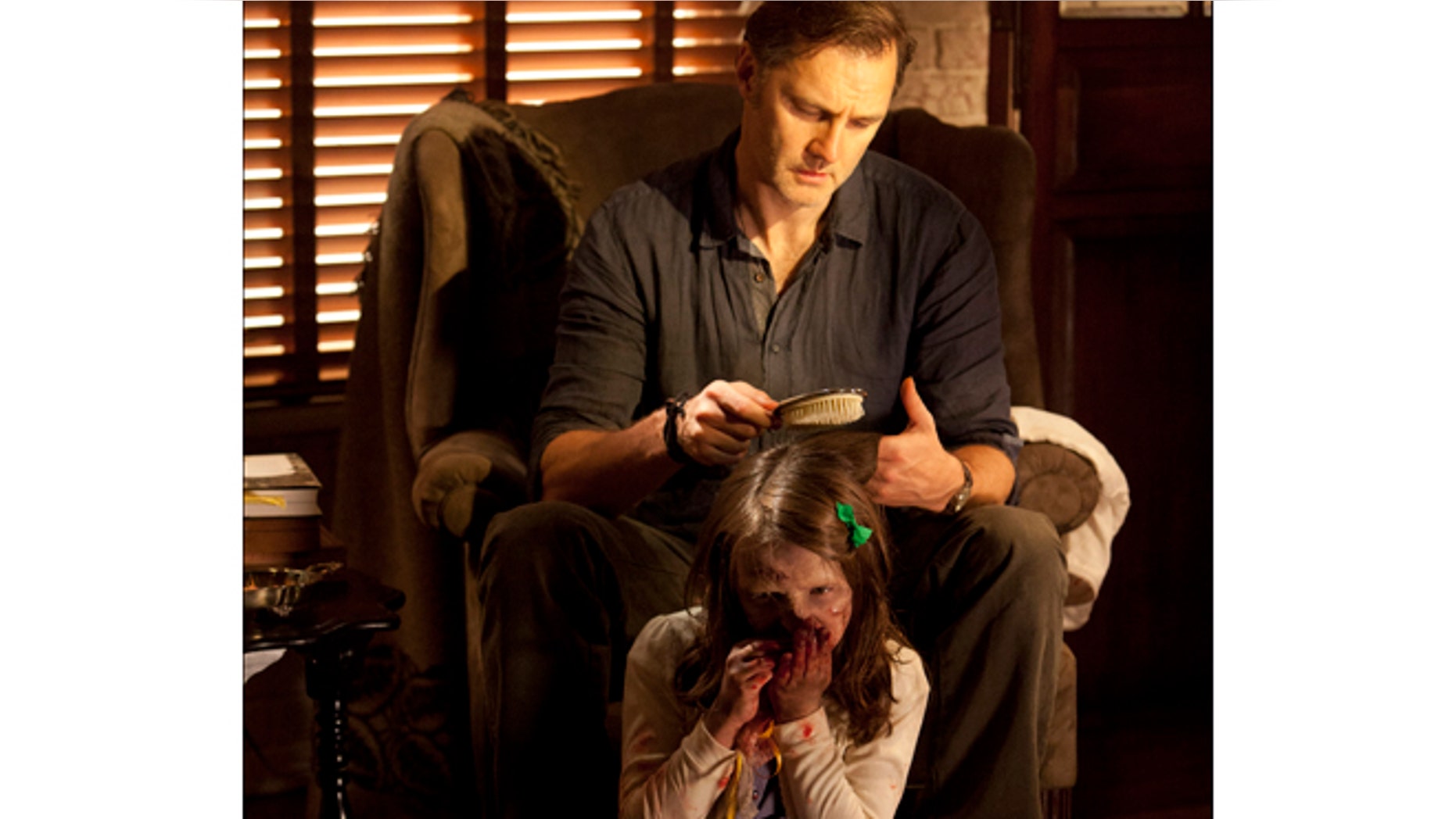 This undated image released by AMC shows David Morrisey as The Governor brushing the hair of Kylie Szymanski as Penny in a scene from the third season of "The Walking Dead."