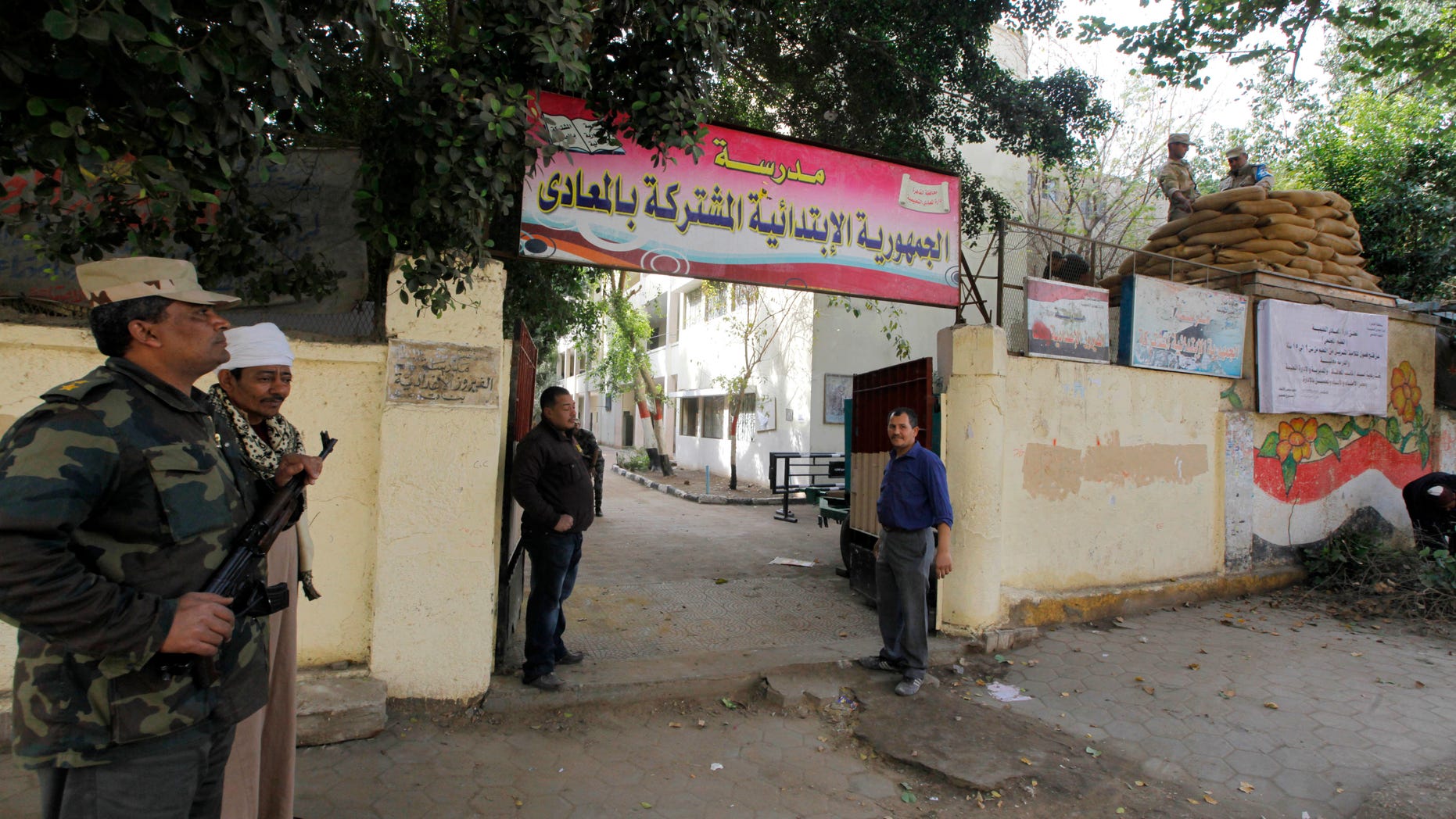 Egyptian army soldiers and plainclothes policemen guard a polling station in Cairo, Egypt, Monday, Jan. 13, 2014. The January 14-15 vote on the draft constitution will be the first real test of the post-Mohammed Morsi regime. A comfortable "yes" vote and a respectable turnout would be seen as bestowing legitimacy, while undermining the Islamists' argument that Morsi remains the nation's elected president. (AP Photo/Amr Nabil)
