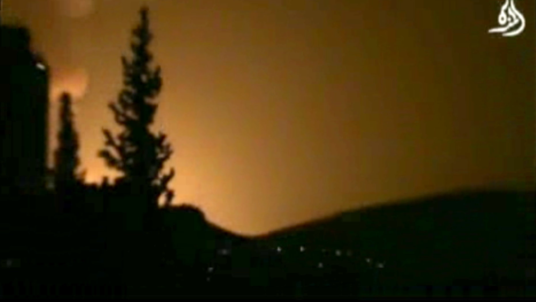 In this image taken from video obtained from Shaam News Network, which has been authenticated based on its contents and other AP reporting, smoke and fire fill the skyline over Damascus, Syria, early Sunday, May 5, 2013 after an Israeli airstrike. Israeli warplanes struck areas in and around the Syrian capital Sunday, setting off a series of explosions as they targeted a shipment of highly accurate, Iranian-made guided missiles believed to be on their way to Lebanon's Hezbollah militant group, officials and activists said. The attack, the second in three days, signaled a sharp escalation of Israel's involvement in Syria's bloody civil war. Syria's state media reported that Israeli missiles struck a military and scientific research center near the Syrian capital and caused casualties. (AP Photo/Shaam News Network via AP video)