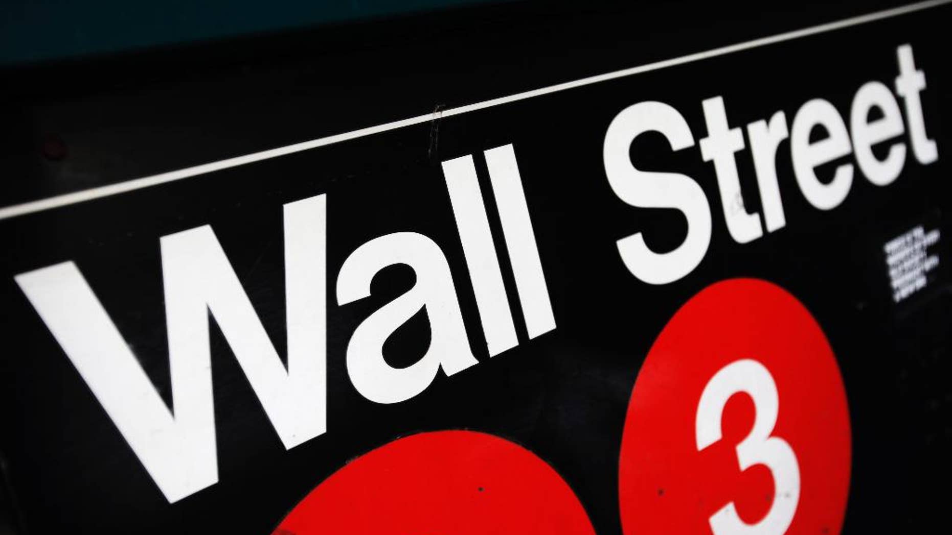 FILE - This Jan. 4, 2010 file photo shows an entrance to a Wall Street subway station in New York. Global stocks markets were mostly higher Thursday Sept. 25, 2014 after a surge in new home sales in the U.S. bolstered sentiment. But gains were limited by worries about Europe's stagnant economy and violence in Iraq and Syria. (AP Photo/Mark Lennihan, File)