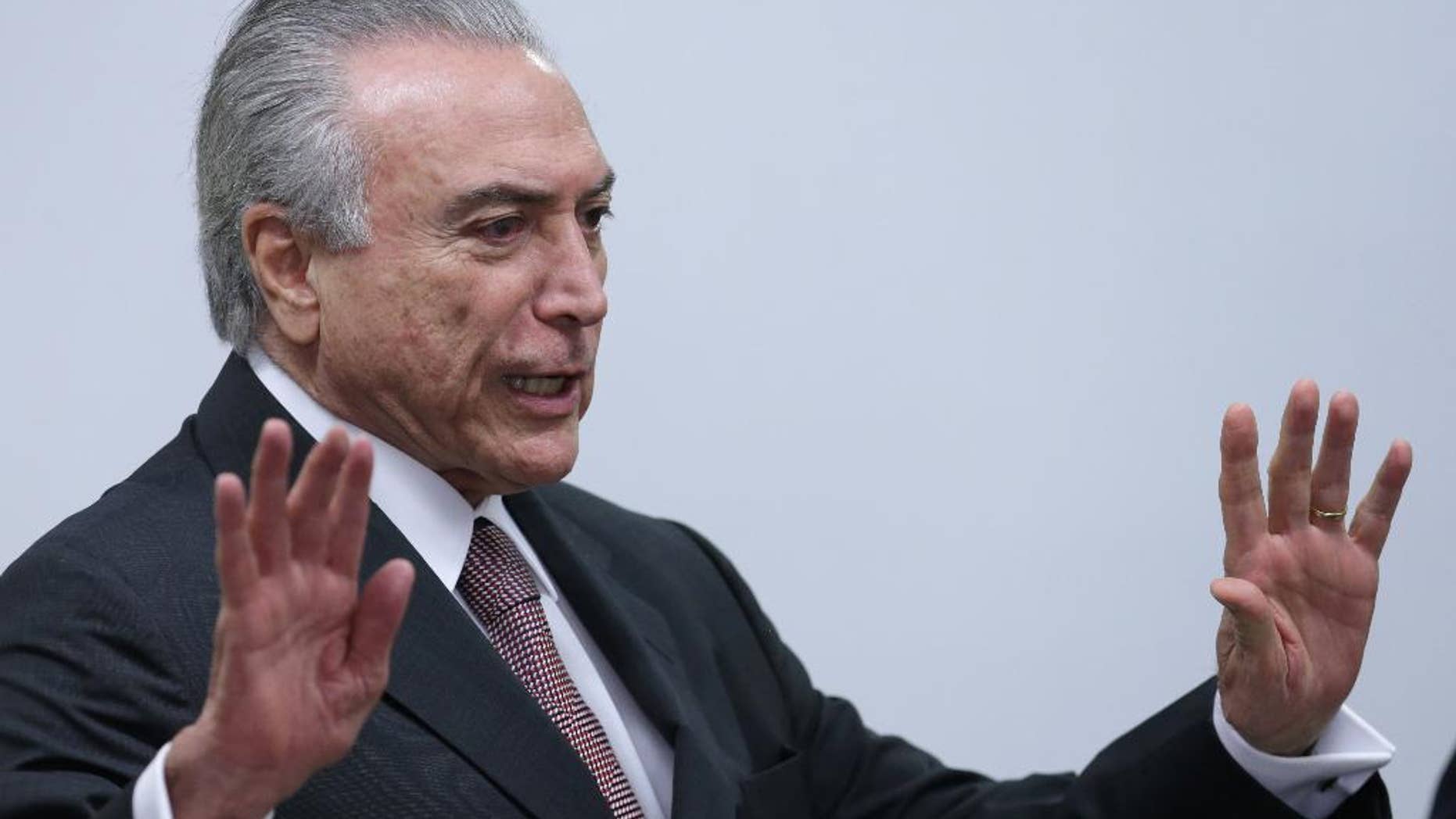 Brazil's acting President Michel Temer arrives to attend a meeting of ministers and military commanders on the preparations for the Rio 2016 Olympic Games, at the Planalto Presidential Palace, in Brasilia, Brazil, Monday, May 16, 2016. Temer assumed the presidency last week after President Dilma Rousseff was impeached and suspended for allegedly employing accounting tricks to hide gaping deficits in the federal budget. (AP Photo/Eraldo Peres)