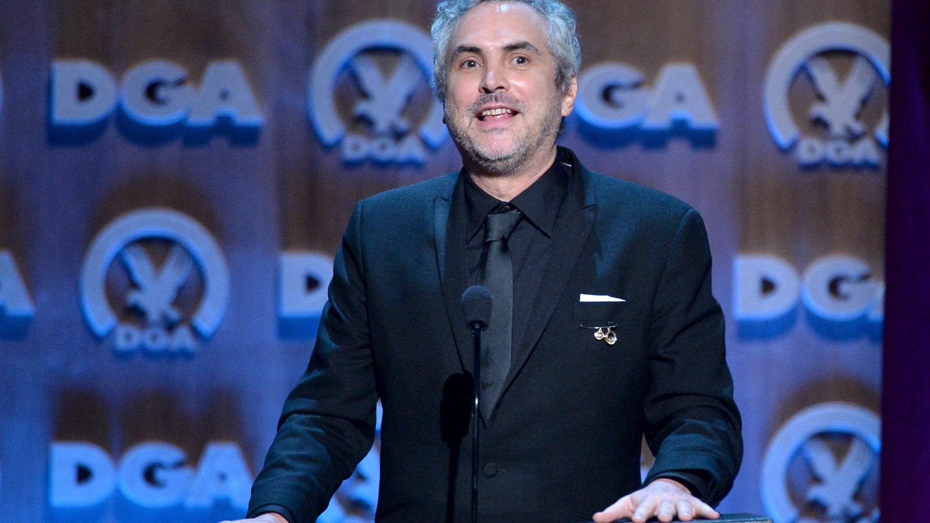 CENTURY CITY, CA - JANUARY 25: Director Alfonso Cuaron accepts the Outstanding Directorial Achievement in Feature Film for 2013 award for ÂGravity onstage at the 66th Annual Directors Guild Of America Awards held at the Hyatt Regency Century Plaza on January 25, 2014 in Century City, California. (Photo by Alberto E. Rodriguez/Getty Images for DGA)