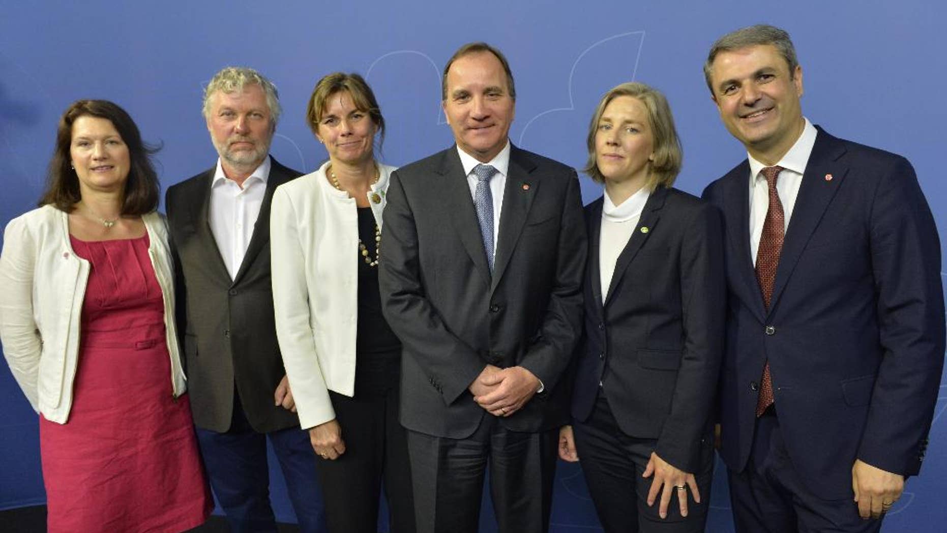 Swedish Prime Minister Stefan Lofven, centre, poses with members of his new Cabinet, with left to right, Ann Linde EU and trade; Peter Eriksson housing and digitizing; Isabella Lovin international development and climate; Prime Minister Stefan Lofven, Karolina Skog environment; Ibrahim Baylan coordination and energy, during a press conference after a government reshuffle Wednesday May 25, 2016. (Jonas Ekstromer / TT via AP) SWEDEN OUT