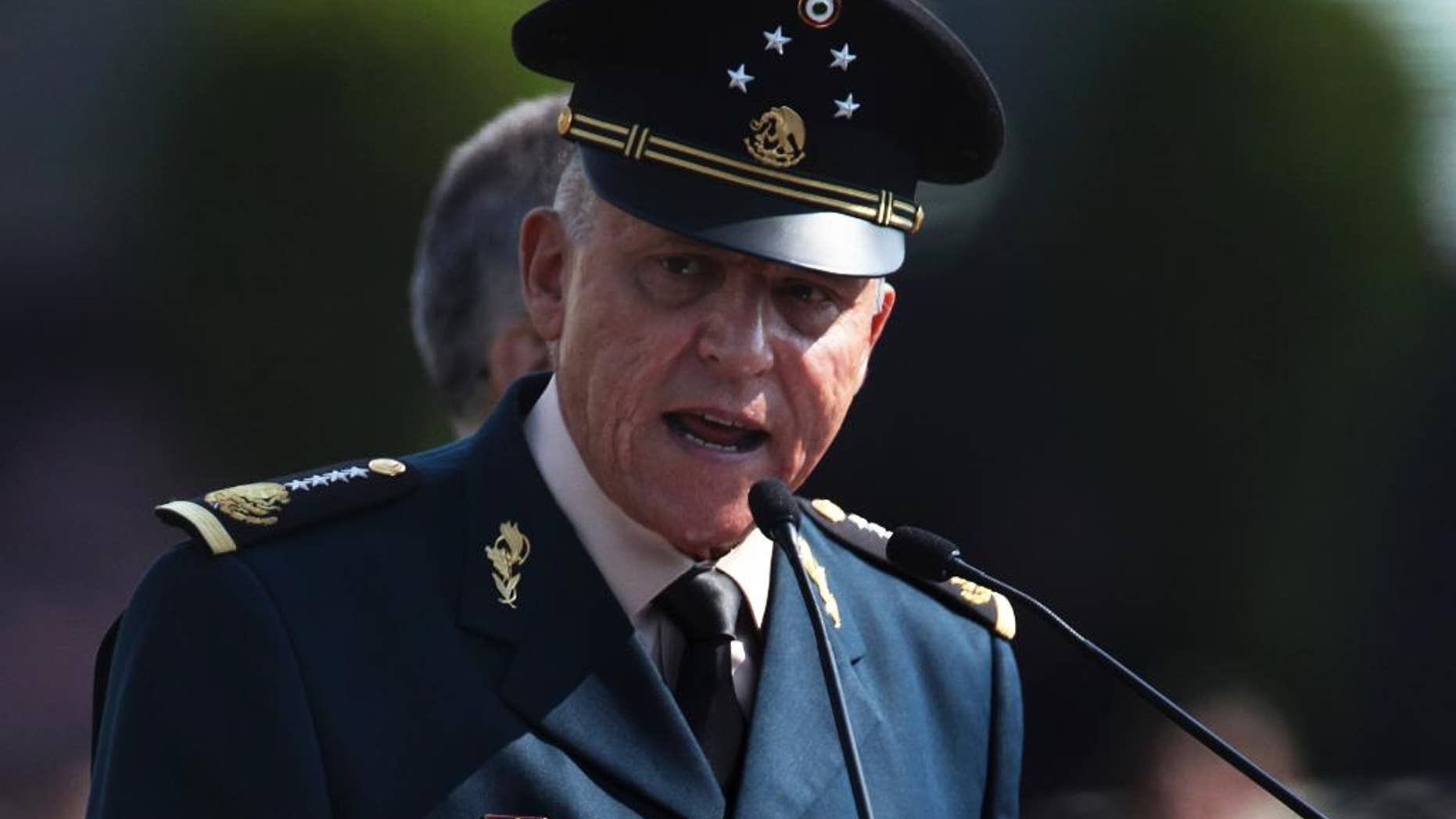 FILE - In this April 16, 2016, file photo, Mexico's Defense Secretary Gen. Salvador Cienfuegos Zepeda speaks to soldiers at the Number 1 military camp in Mexico City. Cienfuegos said Thursday, Dec. 8, that the army is uncomfortable with the law-enforcement role it was given a decade ago when the government launched an offensive against drug cartels. (AP Photo/Marco Ugarte, File)