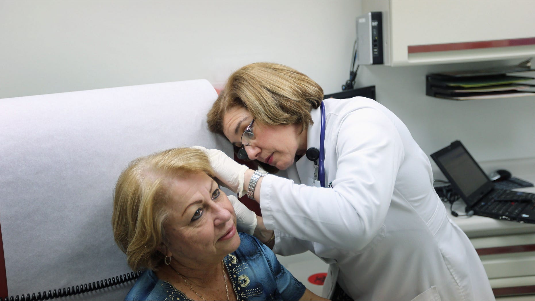 MIAMI, FL - FEBRUARY 21: Dr. Martha Perez examines Maria Lebron in a room at the Community Health of South Florida, Doris Ison Health Center on February 21, 2013 in Miami, Florida. Florida Gov. Rick Scott reversed himself on February 20, and now is callling for an expansion of Medicaid to Florida residents under the federal Affordable Care Act. (Photo by Joe Raedle/Getty Images)
