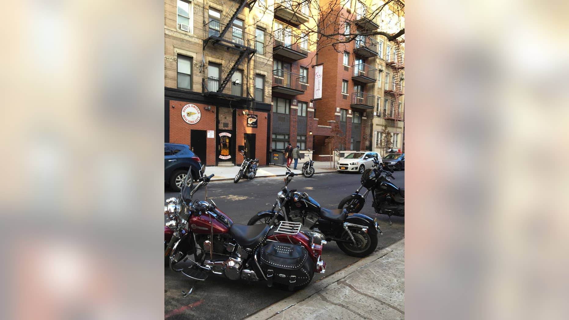 FILE- In this Dec. 16, 2016 file photo, motorcycles are parked on the street outside the Hells Angels motorcycle club headquarters in New York. Authorities said that a man affiliated with the Hells Angels was charged Wednesday, Dec. 21, 2016 in a shooting sparked by a dispute over a parking spot outside the motorcycle club's headquarters on Dec. 11. (AP Photo/Tom Hays, File)