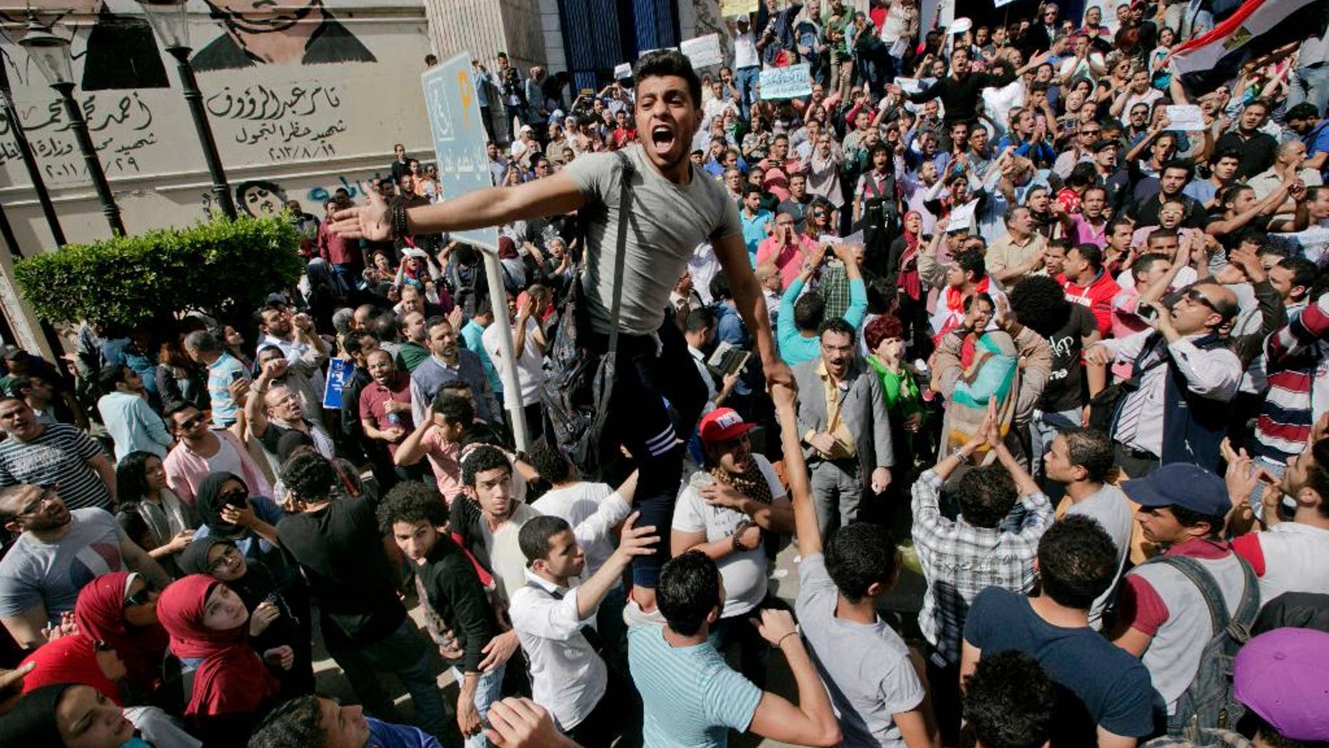 FILE - In this Friday, April 15, 2016 file photo, Egyptians shout slogans against Egyptian President Abdel-Fattah el-Sissi during a protest against the decision to hand over control of two strategic Red Sea islands to Saudi Arabia in front of the Press Syndicate, in Cairo, Egypt. Egyptian security forces have rounded up dozens of activists, journalists, and lawyers ahead of demonstrations called for April 25 against President Abdel-Fattah el-Sissi's policies, including the transfer of two Red Sea islands to Saudi Arabia, lawyers and witnesses said Friday, April 22. 2016. (AP Photo/Amr Nabil, File)