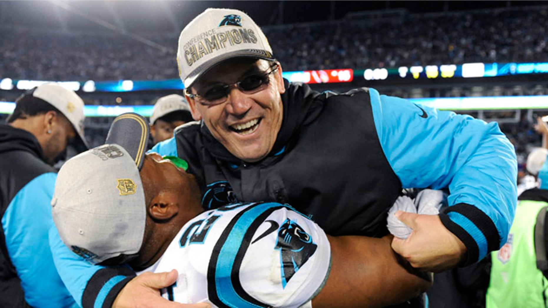 Carolina Panthers head coach Ron Rivera celebrates with Jonathan Stewart after the NFL football NFC Championship game against the Arizona Cardinals, Sunday, Jan. 24, 2016, in Charlotte, N.C. The Panthers won 49-15 to advance to the Super Bowl. (AP Photo/Mike McCarn)