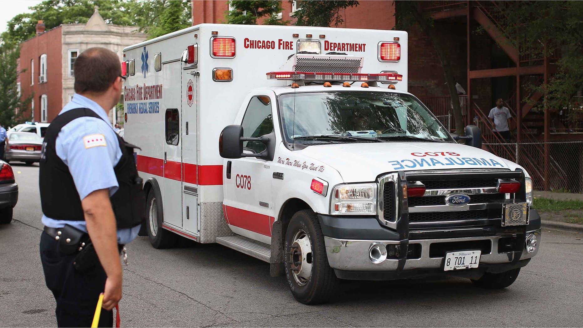 CHICAGO, IL - JULY 06: An ambulance leaves a crime scene where seven people were shot on July 6, 2013 in Chicago, Illinois. Two days earlier and half of a block away Steve Mabins, 21, was shot and killed on his way to an Independence Day party. More than 60 people have been shot in Chicago since Wednesday, at least nine fatally. (Photo by Scott Olson/Getty Images)