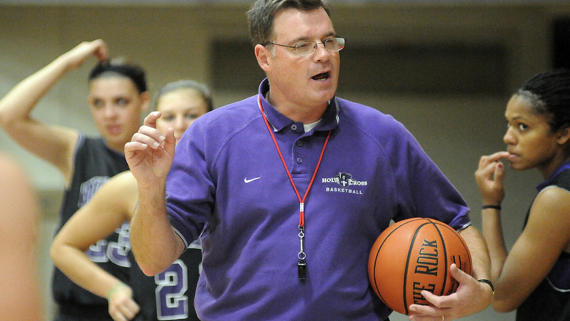 In this Nov. 4, 2010 photo, Holy Cross women's basketball coach Bill Gibbons outlines a play for his team during practice at the Hart Center in Worcester, Mass. Former Holy Cross player Ashley Cooper, 20, filed a lawsuit in New York Tuesday, Oct. 15, 2013, against the school, Gibbons, and school officials claiming Gibbons was "verbally, emotionally and physically abusive." (AP Photo/The Telegram & Gazette, Steve Lanava)