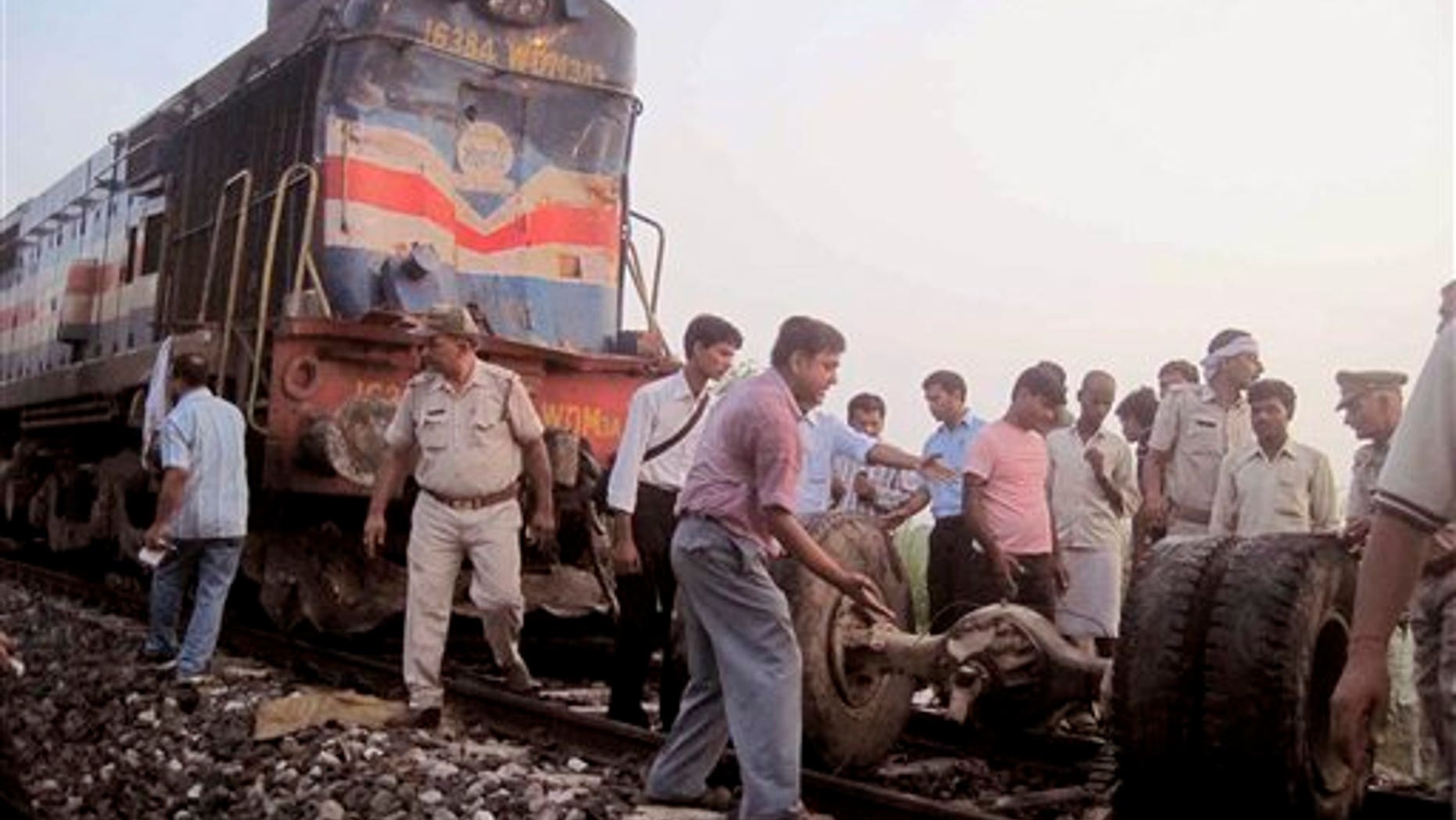 July 07: Volunteers help look for survivors and clear debris after a deadly collision between a train and a bus left 35 dead.
