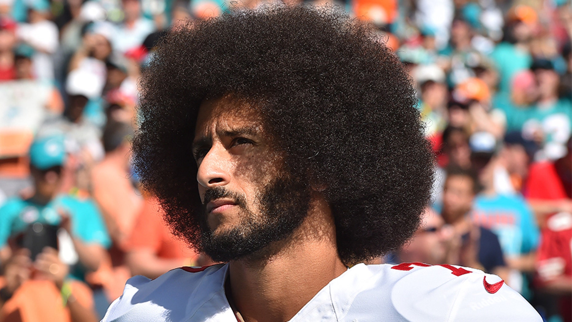 Nov. 27, 2016: Colin Kaepernick looks on before a game against the Miami Dolphins at Hard Rock Stadium.