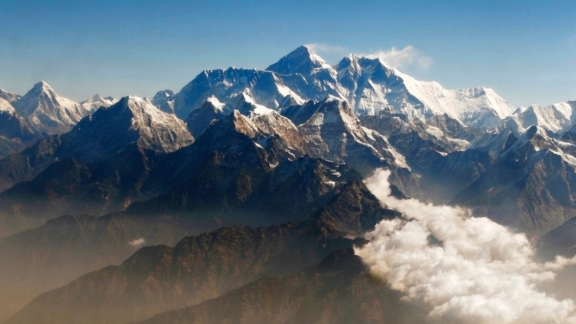 Mount Everest (C), the world highest peak, and other peaks of the Himalayan range are seen from air during a mountain flight from Kathmandu April 24, 2010. (REUTERS/Tim Chong)