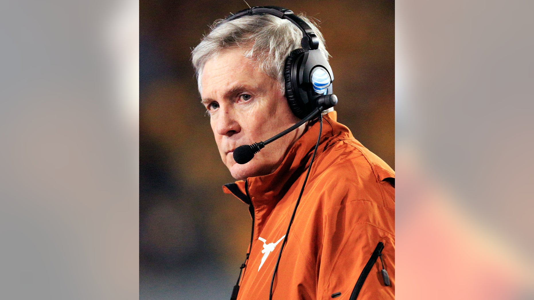 FILE - In this Nov. 9, 2013, file photo, Texas coach Mack Brown watches his team during the second quarter of an NCAA college football game against West Virginia in Morgantown, W.Va. Brown's attorney says the Texas coach has not resigned, denying a report on Tuesday, Dec. 10, 2013, that Brown was ready to step down after 16 seasons with the Longhorns. (AP Photo/Christopher Jackson, File)
