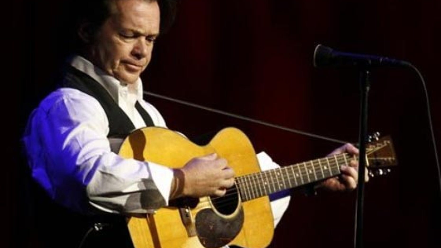 Musician John Mellencamp plays during a tribute to former NCAA president Myles Brand in Indianapolis, Wednesday, Oct. 28, 2009. Brand died Sept. 16 at age 67 from pancreatic cancer. (AP Photo/Darron Cummings)