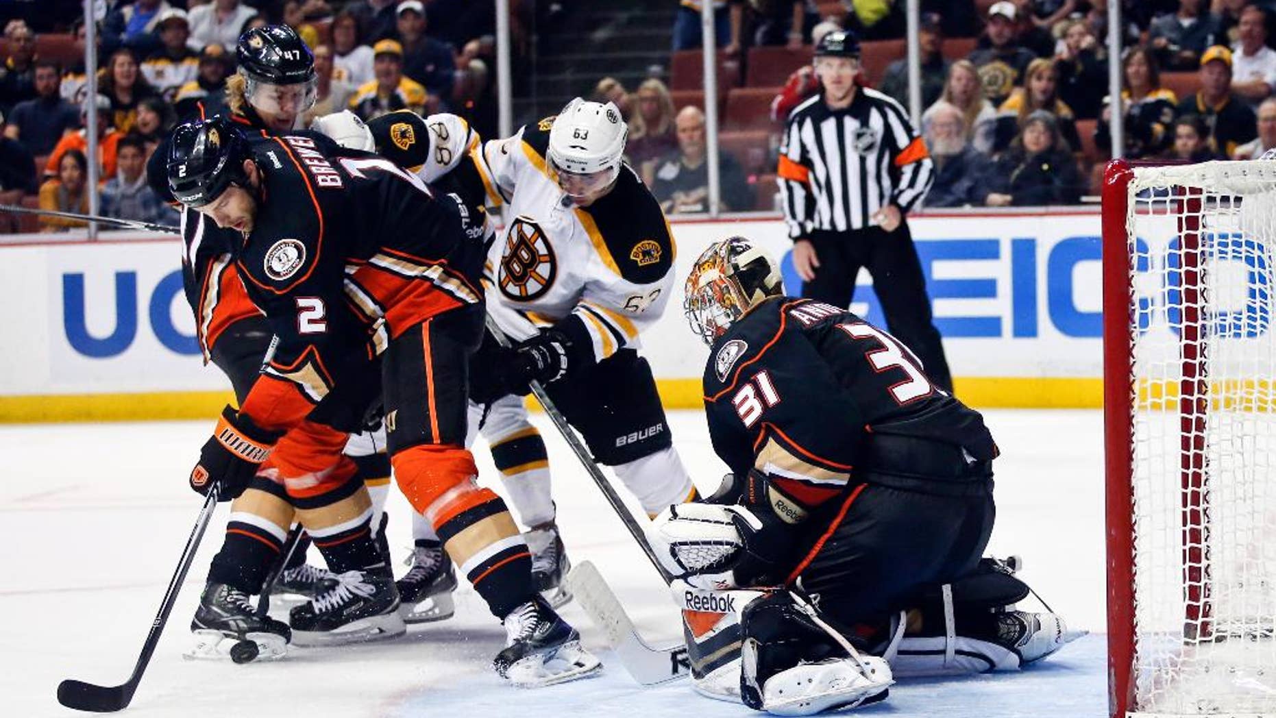 Anaheim Ducks defenseman Eric Brewer, left, grabs the rebound after a stop by Ducks' goalie Frederik Andersen during the third period of an NHL hockey game Monday, Dec. 1, 2014, in Anaheim, Calif. (AP Photo/Lenny Ignelzi)