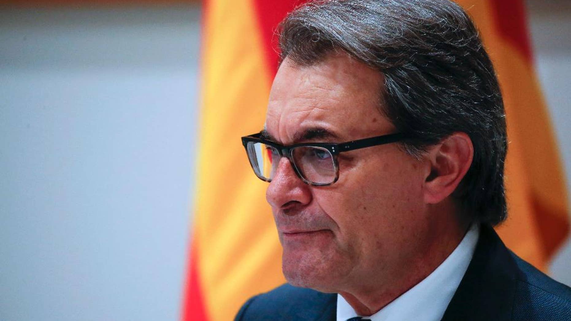 FILE - In this Jan. 9, 2016 file photo, acting regional President Artur Mas pauses during a news conference in Barcelona. Spanish prosecutors said on Monday, Oct. 3, 2016 that they are seeking a 10-year disqualification from holding public office for former Catalan regional President Artur Mas for staging a vote on Catalonia's secession from Spain despite a suspension order by the Constitutional Court. (AP Photo/Emilio Morenatti, File)