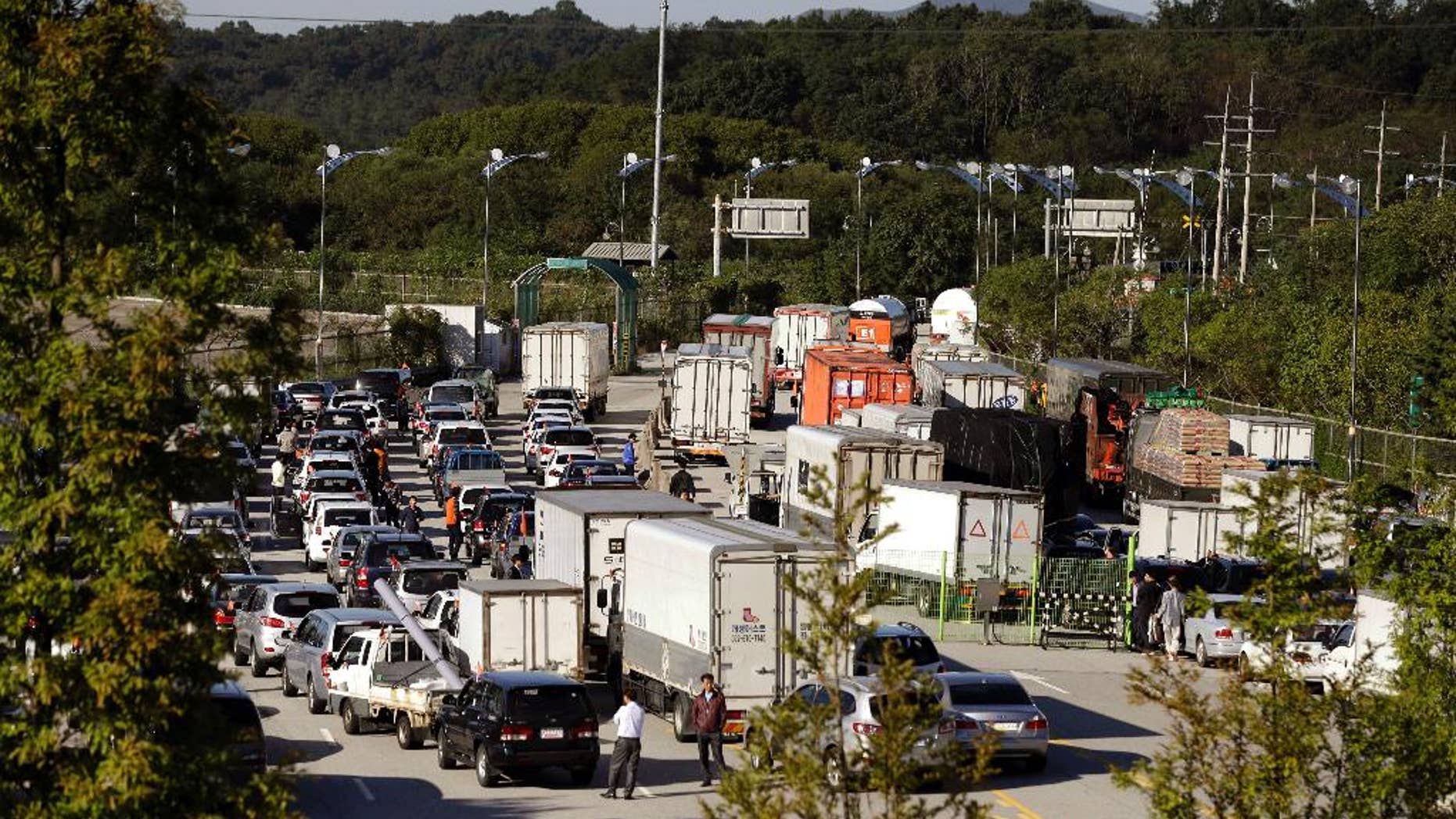 FILE - In this Sept. 16, 2013 file photo, South Korean vehicles leave for the Kaesong Industrial Complex at the customs, immigration and quarantine area of the Inter-Korean Transit Office near the border village of Panmunjom, which has separated the two Koreas since the Korean War, in Paju, north of Seoul, South Korea. North Korea on Friday, Nov. 6, 2015 lifted entry bans it had imposed earlier this week on two South Korean officials involved in managing the jointly-run factory park in the North. (AP Photo/Lee Jin-man, File)