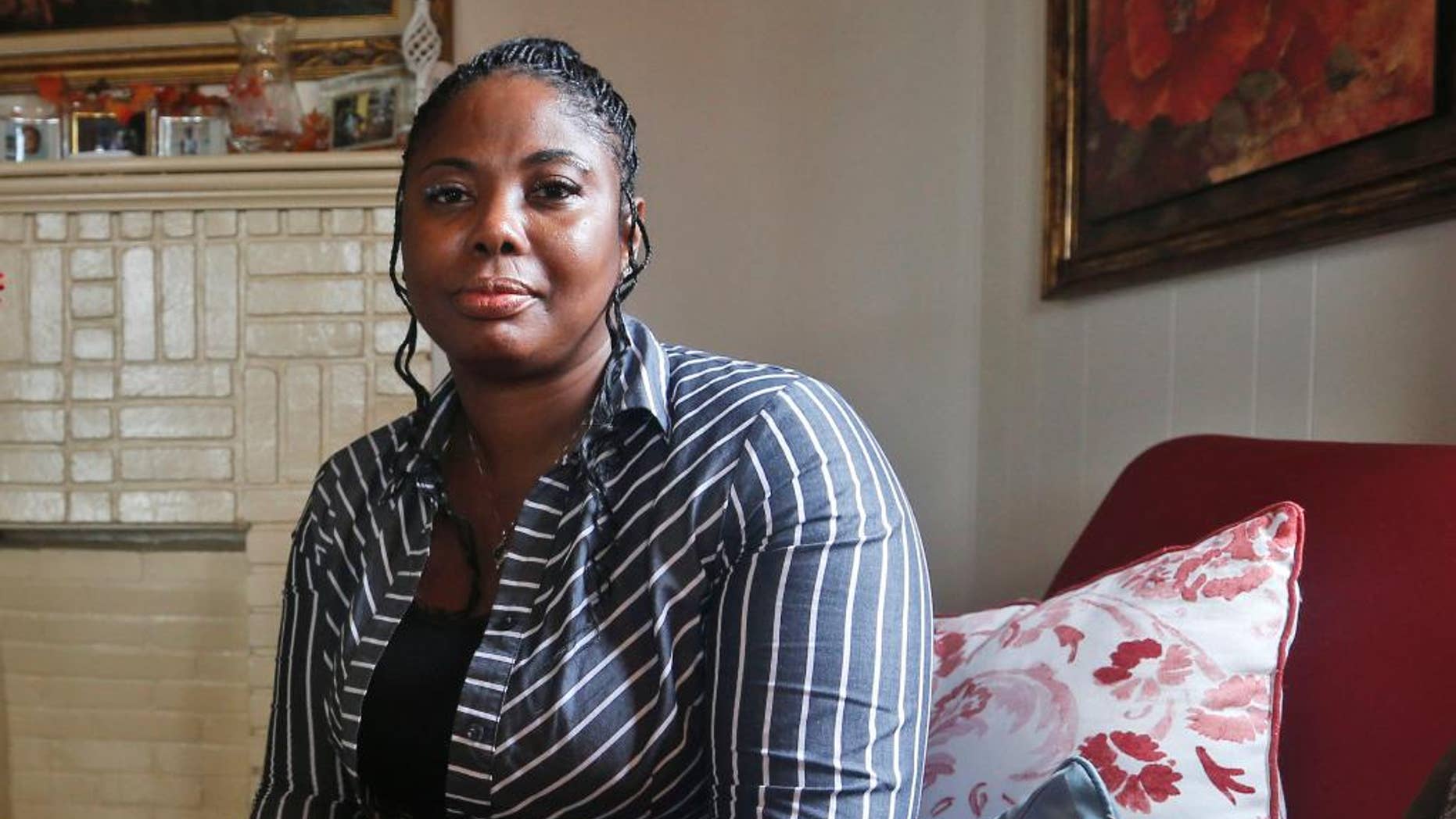 FILE- In this Nov. 12, 2015, file photo, Gwendolyn Smalls poses for a photo in her home in Richmond, Va. Smalls' brother, Linwood R. Lambert Jr., died in police custody in May of 2013 after being repeatedly stunned by South Boston police. U.S. Attorney John Fishwick Jr. said Thursday, Sept. 22, 2016, that he will not pursue federal criminal civil rights charges against three Virginia police officers who used stun guns multiple times onLambert Jr. before his death. The officers face a $25 million civil lawsuit filed by Gwendolyn Smalls. A trial was originally set for early 2017, but he officers’ attorneys have asked for it to be pushed back until later in the year. (AP Photo/Steve Helber, File)