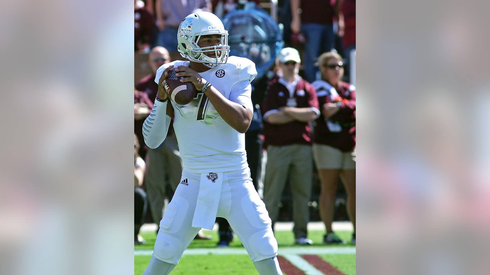 Texas A&M quarterback Kenny Hill (7) prepares throw a pass during the first half of an NCAA college football game against Mississippi State in Starkville, Miss., Saturday, Oct. 4, 2014. (AP Photo/Jim Lytle)
