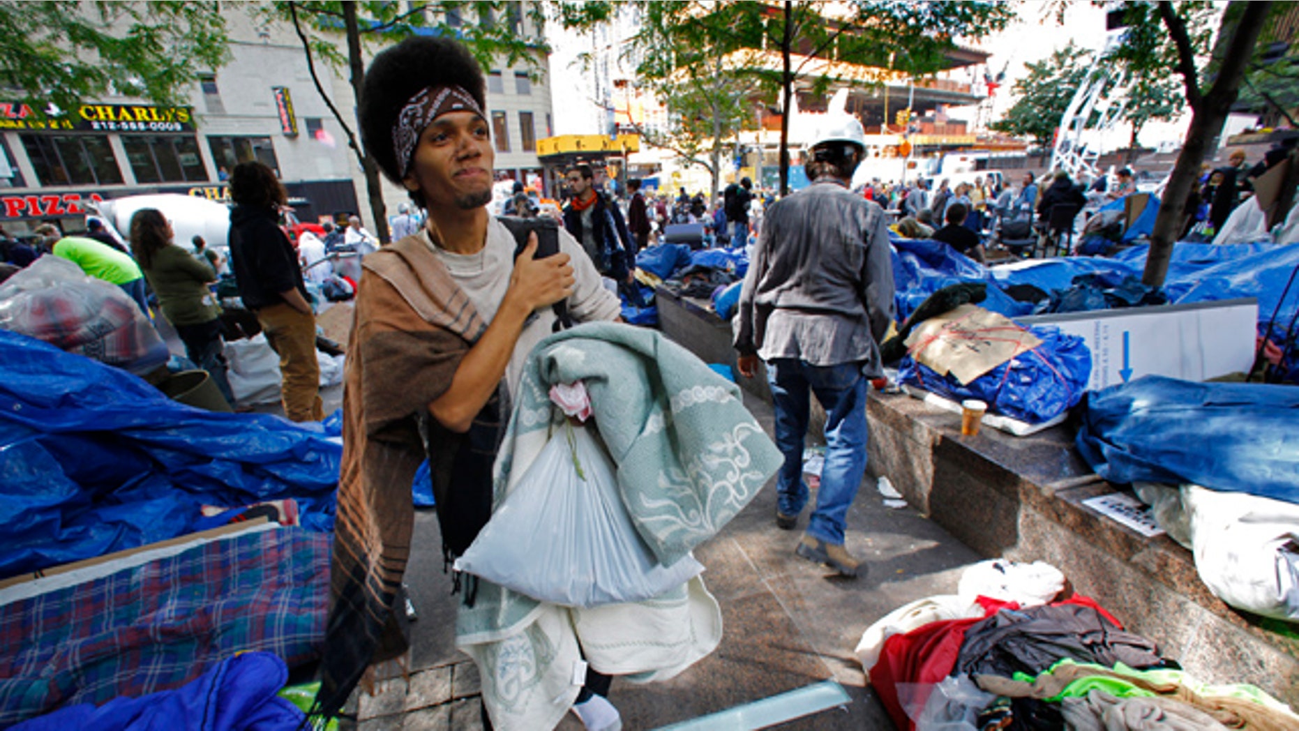 Oct. 5: Christian Blackfeather Ruiz, 19, from Bronx, New York, searches for a spot to camp among participants in the Occupy Wall Street Protest at Zuccotti Park in lower Manhattan. "I am here for a global economy," said Ruiz.