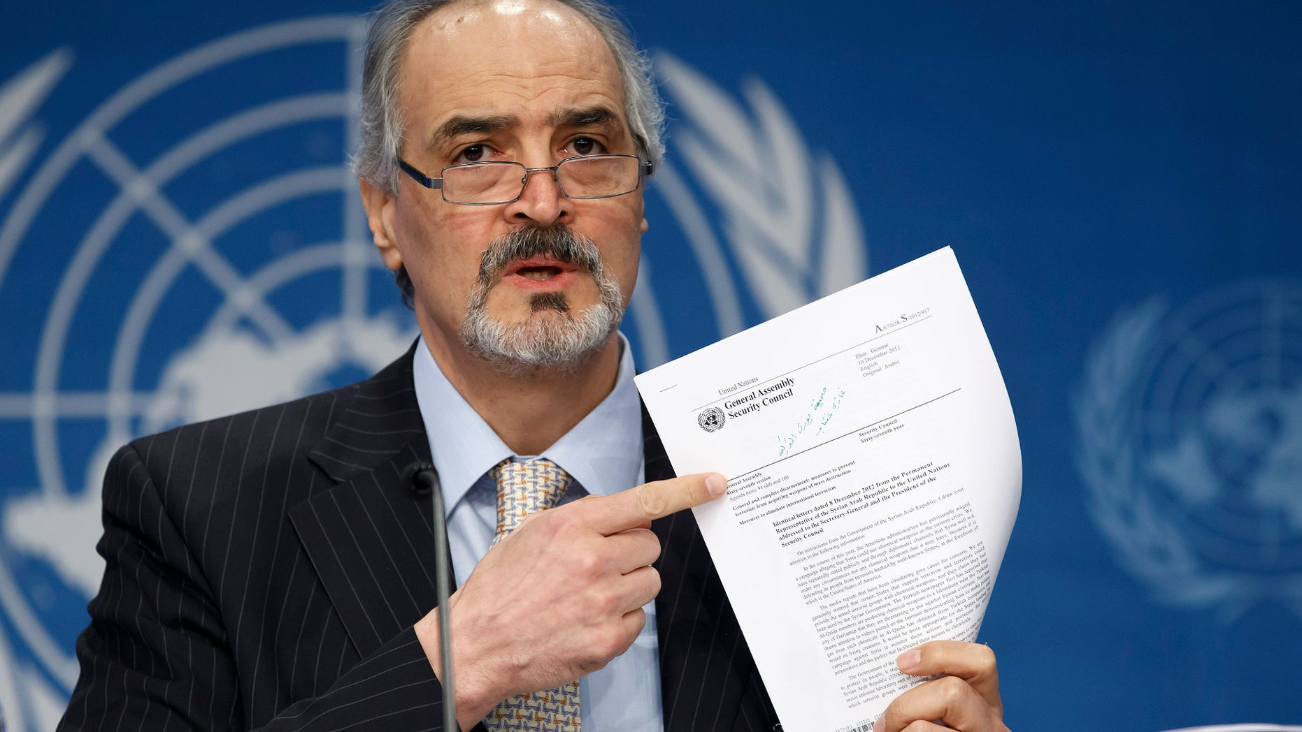Syrian Ambassador to the United Nations, Bashar Ja'afari, points to a document during a press conference during the Syrian peace talks in Montreux, Switzerland, Wednesday, Jan. 22, 2014. U.N. Secretary-General Ban Ki-moon opened the meeting saying that the peace talks will face "formidable" challenges for Syria. Ban called on the Syrian government and the opposition trying to overthrow it to negotiate in good faith.(AP Photo/KEYSTONE/Salvatore Di Nolfi)