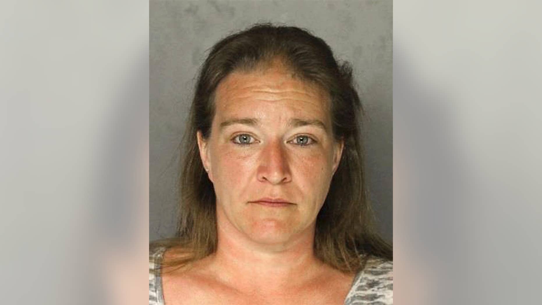 This photo provided by the Allegheny County Police Department in Pittsburgh shows Teresa Drum of Frazer Township, Pa., charged Tuesday, Feb. 28, 2017, with criminal homicide after police say she fatally shot her husband Dennis Drum Sr. on Monday, Feb. 27, then took a cellphone photo of his body and showered before calling 911. Police say she told officers her husband complained she burned a casserole and drank his last beer, then shot himself as she called 911. But police say the photo was taken 11 minutes before the 911 call, and there was no gun in the body's hand in the photo. (Allegheny County Police Department via AP)