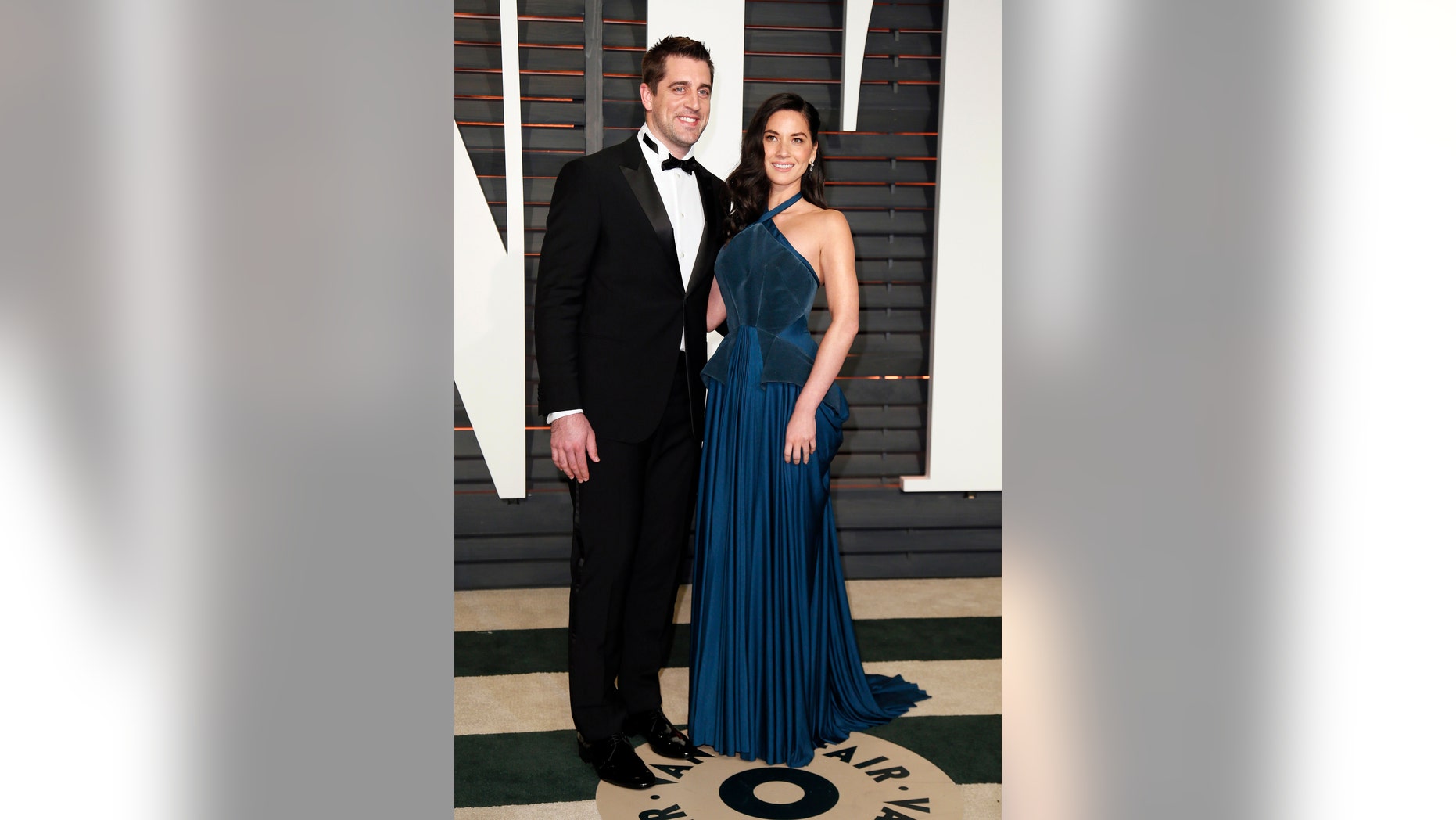 NFL football player Aaron Rogers and actress Olivia Munn arrive at the 2015 Vanity Fair Oscar Party in Beverly Hills, California February 22, 2015.