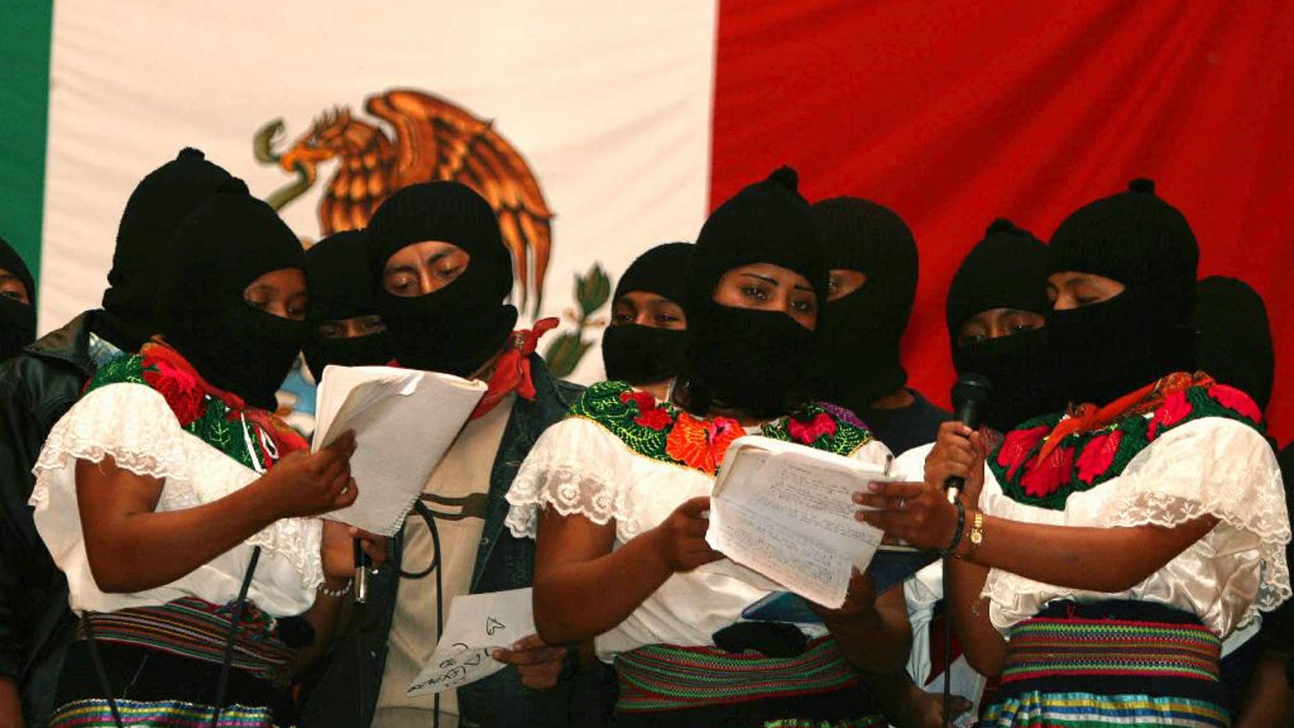 FILE - In this July 24, 2007 file photo, masked female members of the Zapatista National Liberation Army (EZLN), sing during a meeting with supporters in Morelia, Chiapas state, Mexico, after the rebels pledged to move away from armed struggle and toward politics more than a decade after a short-lived revolt for Indian rights and socialism. The EZLN announced on Friday, Oct. 14, 2016 its decision to nominate an indigenous woman as their independent candidate for Mexico's presidency, ahead of 2018 elections. (AP Photo/Moyses Zuniga, File)