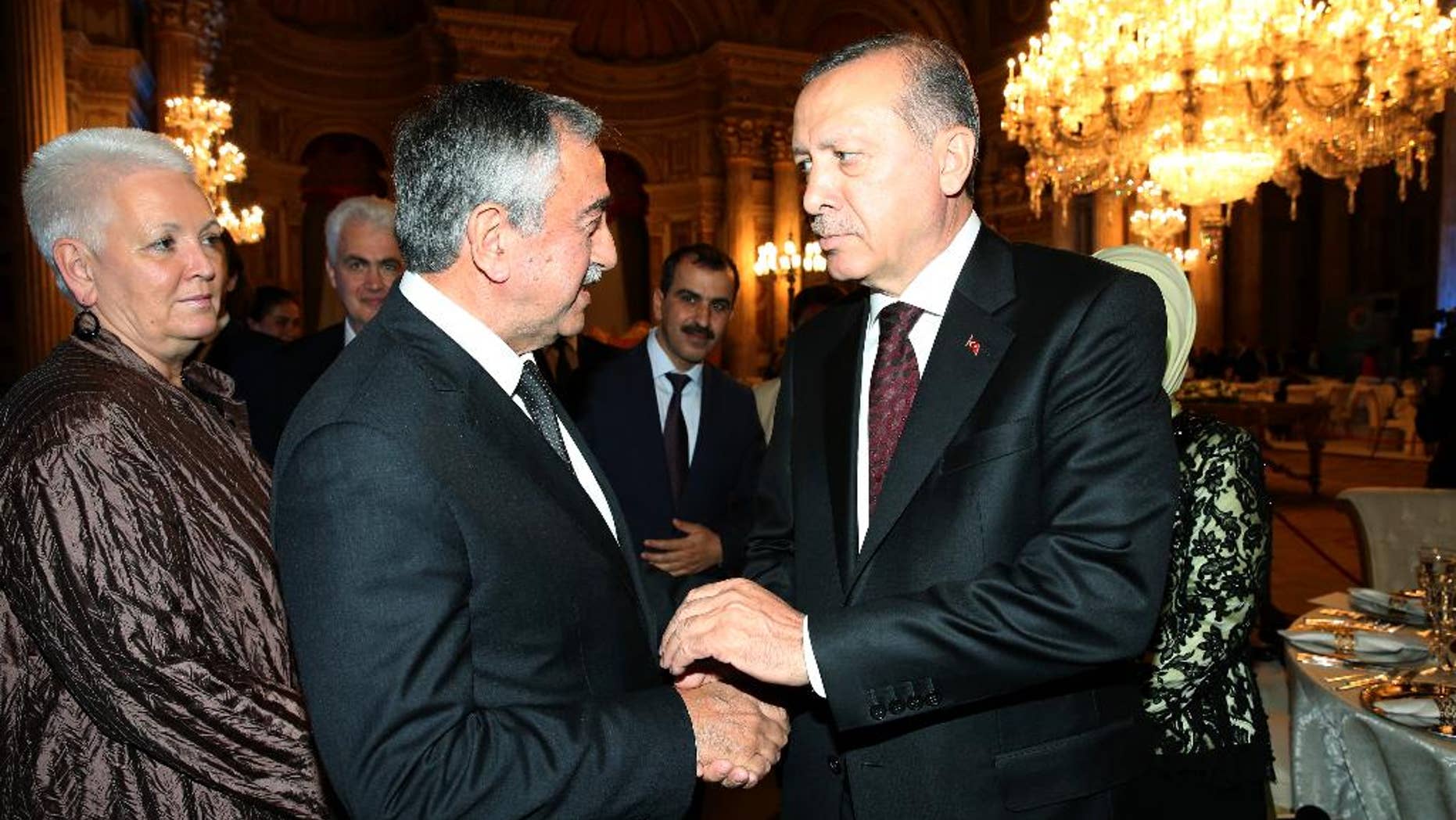 Turkey's President Recep Tayyip Erdogan, right, welcomes Turkish Cypriot leader Mustafa Akinci, center, prior to a dinner at the historical Dolmabahce Palace in Istanbul, Monday, May 23, 2016. World leaders and representatives of humanitarian organizations from across the globe are converging in Istanbul for the first World Humanitarian Summit. (Murat Cetinmuhurdar/Presidential Press Service/Pool Photo via AP)