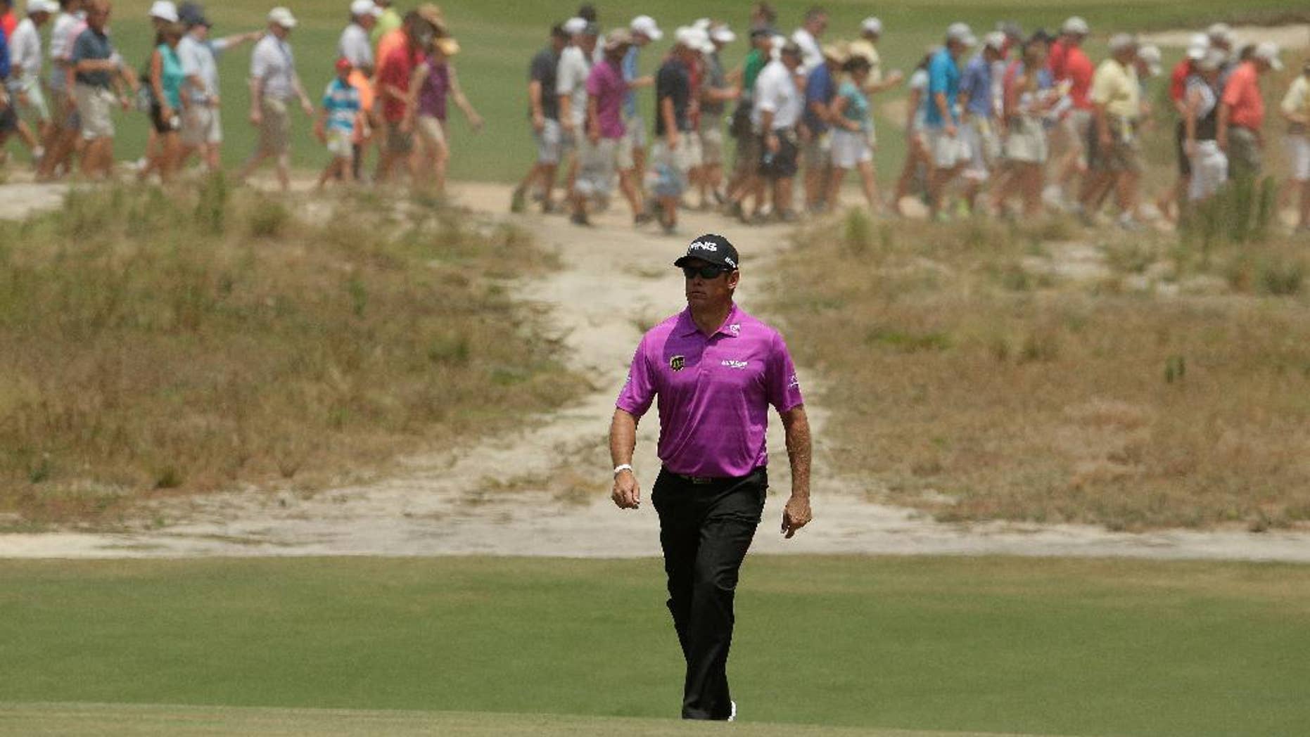 Lee Westwood, of England, walks down the 18th fairway hole during a practice round for the U.S. Open golf tournament in Pinehurst, N.C., Wednesday, June 11, 2014. The tournament starts Thursday. (AP Photo/Charlie Riedel)