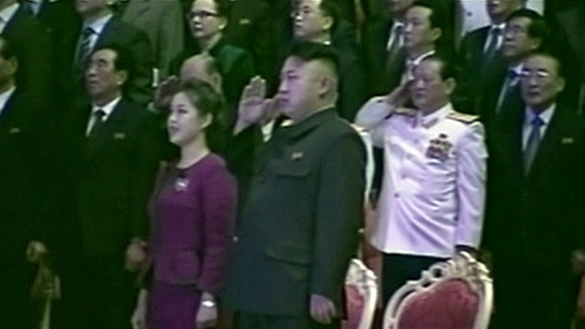 In this Tuesday, Jan. 1, 2013 image made from video, North Korean leader Kim Jong Un, center right, salutes as he and his wife Ri Sol Ju, center left, attend a New Year's concert in Pyongyang, North Korea.