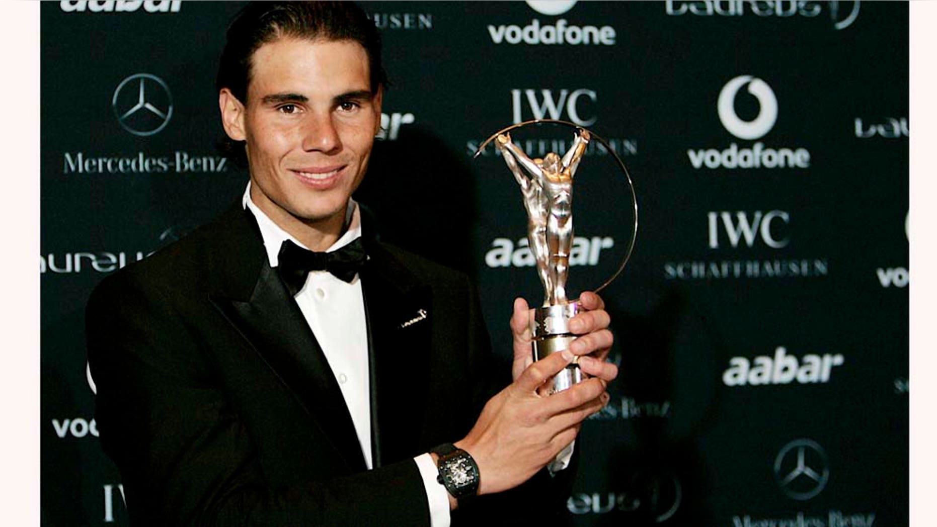 Rafael Nadal holds the trophy after winning the Laureus World Sportsman of the Year at the Laureus Awards in Abu Dhabi, United Arab Emirates, Monday Feb. 7, 2011. (AP Photo/Nousha Salimi)