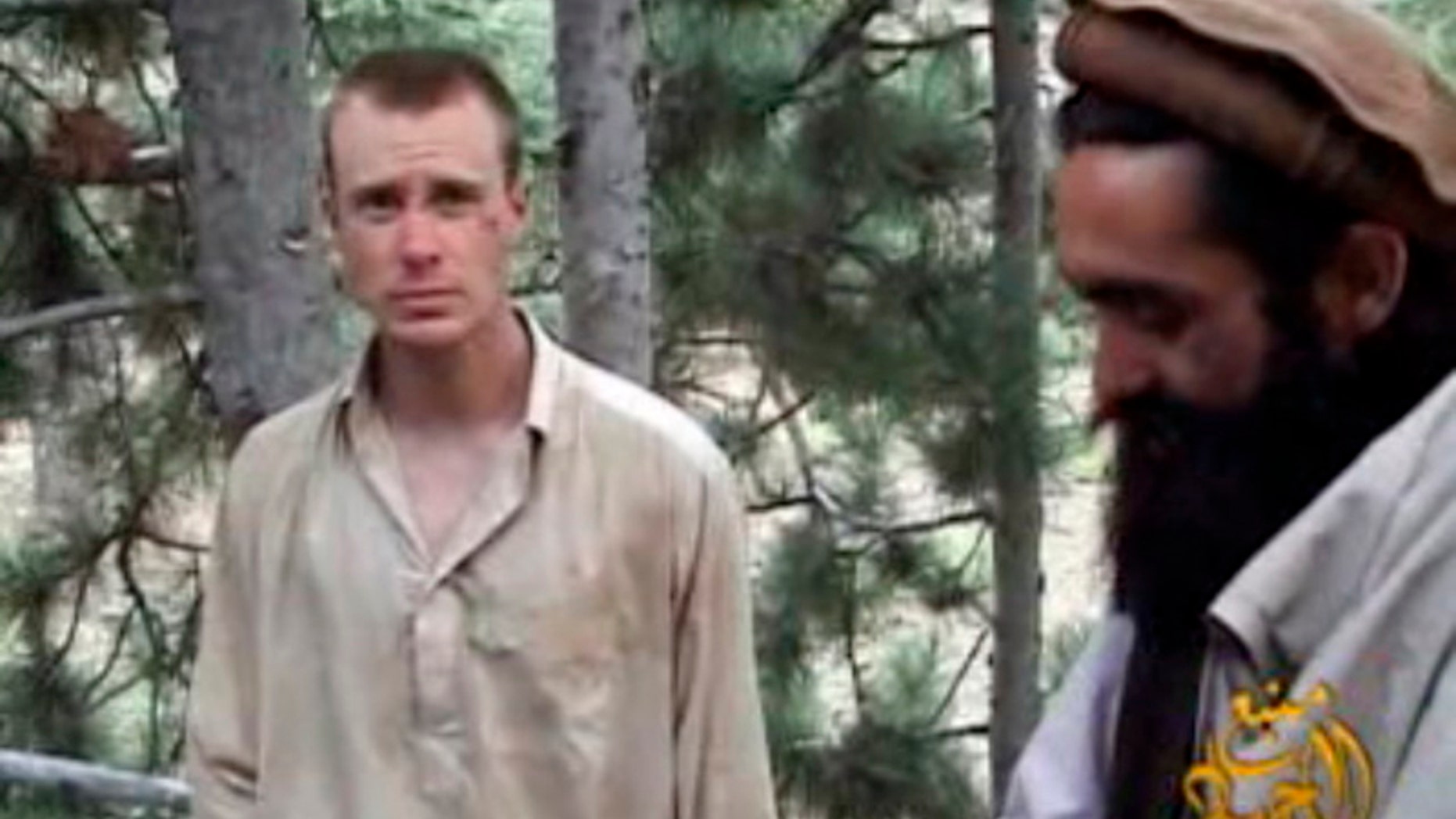 Dec. 8, 2010: This file image provided by IntelCenter shows a framegrab from a video released by the Taliban containing footage of a man believed to be Sgt. Bowe Bergdahl, left. (AP/Intel Center)