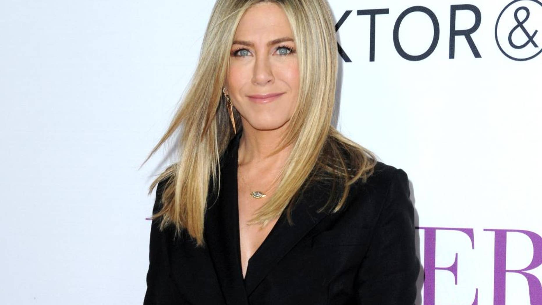 FILE - In this April 13, 2016 file photo, Jennifer Aniston arrives at the Los Angeles premiere of "Mother's Day." Aniston says she’s not pregnant and she’s fed up with predatory tabloid culture that defines women by their looks and maternal status. (Photo by Richard Shotwell/Invision/AP, File)