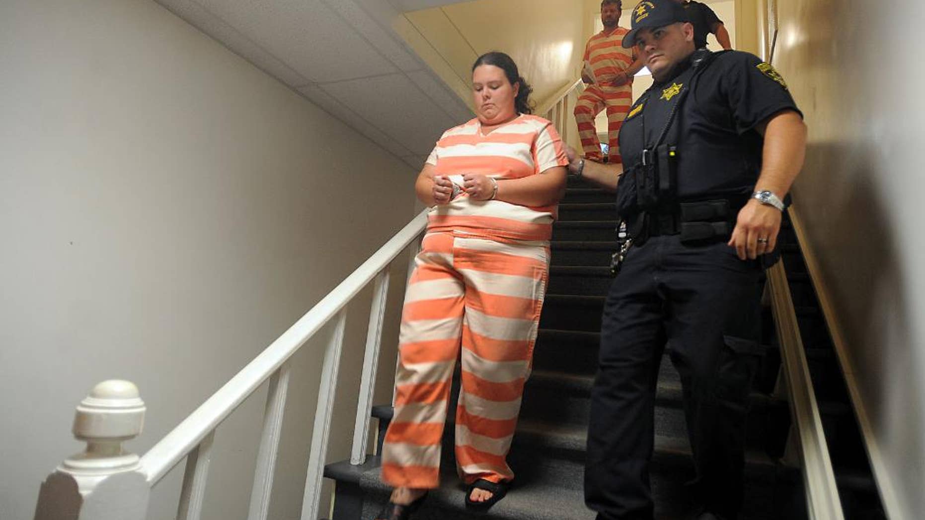 In this Aug. 15, 2014 photo, sheriff deputies escort Nicole Vaisey, left, and Stephen M. Howells II, to their arraignment on charges of kidnapping and sexually abusing two Amish girls in northern New York. (Melanie Kimbler-Lago/The Watertown Daily Times via AP)