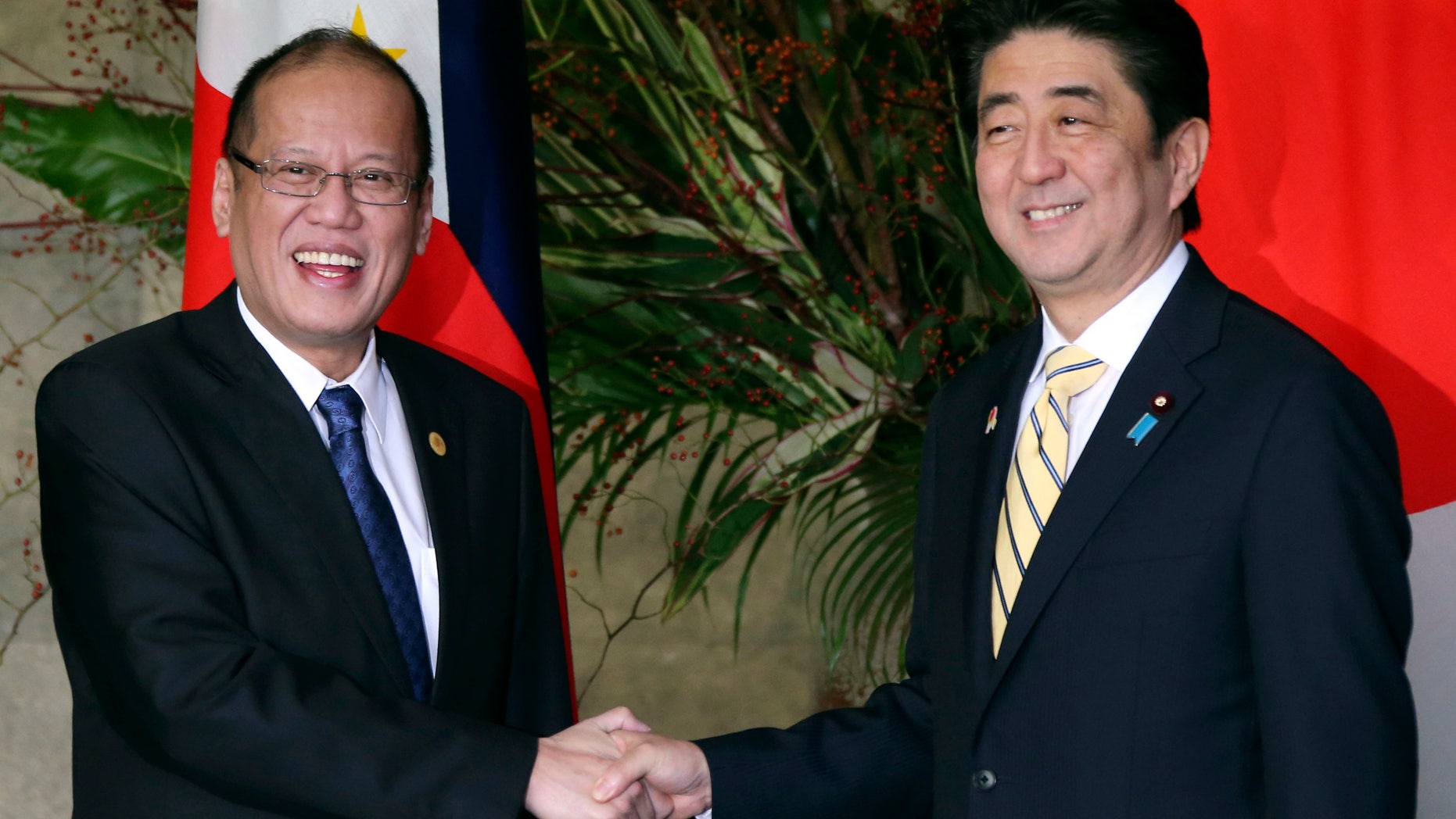 Japanese Prime Minister Shinzo Abe, right, shakes hands with Philippine President Benigno Aquino III prior to their working lunch at Abe's official residence in Tokyo, Friday, Dec. 13, 2013. Aquino is in Tokyo to attend meetings between Japanese and ASEAN leaders. (AP Photo/Koji Sasahara, Pool)