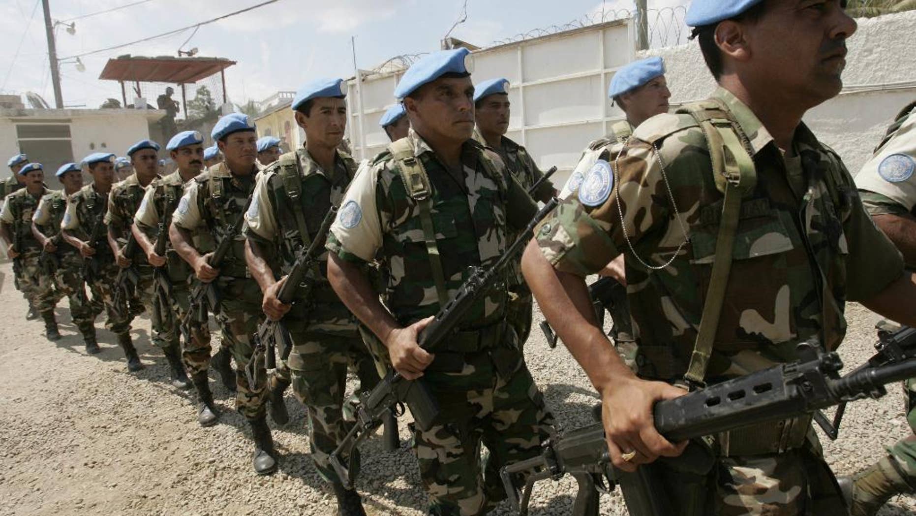 FILE - In this March 26, 2006, file photo, U.N. troops from Uruguay march during a transitional ceremony at the U.N. Spain base in Forte-Liberte, Haiti. Uruguay's president Tabare Vazquez said Monday, March 20, 2017, that his country is pulling its soldiers out of a United Nations peacekeeping mission in Haiti, where they have served since 2004. (AP Photo/Ariana Cubillos, File)
