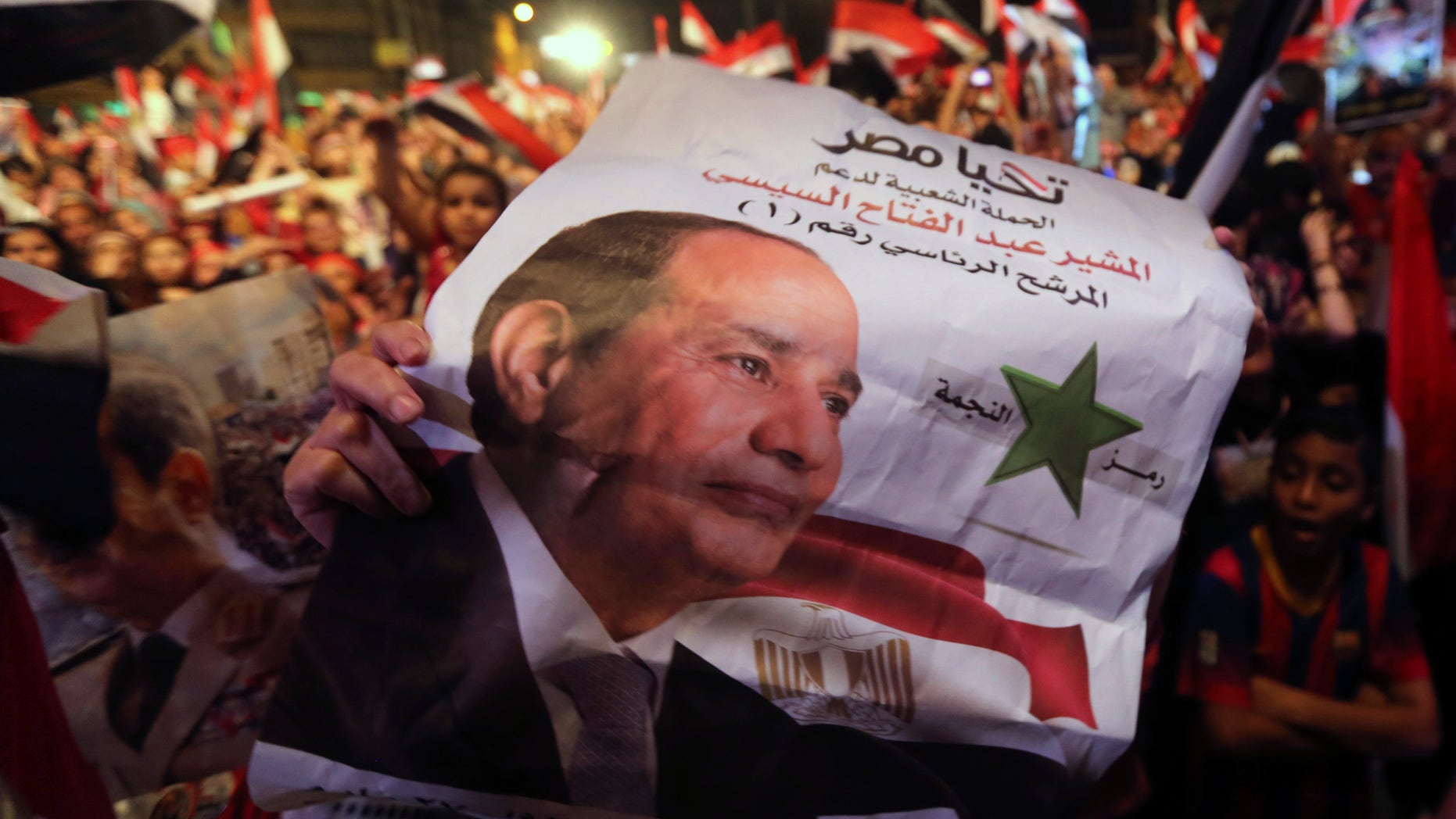 Egyptians gather outside the presidential palace to celebrate former Egyptian army chief Abdel Fattah al-Sisi's victory in the presidential vote in Cairo on June 5, 2014.
