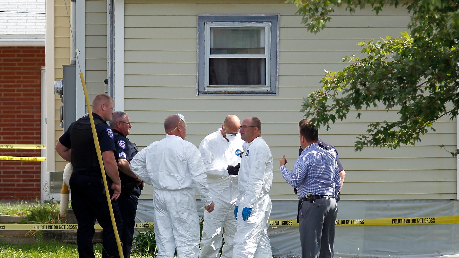 Authorities execute a search warrant on a home on Tuesday in Ashland, Ohio.