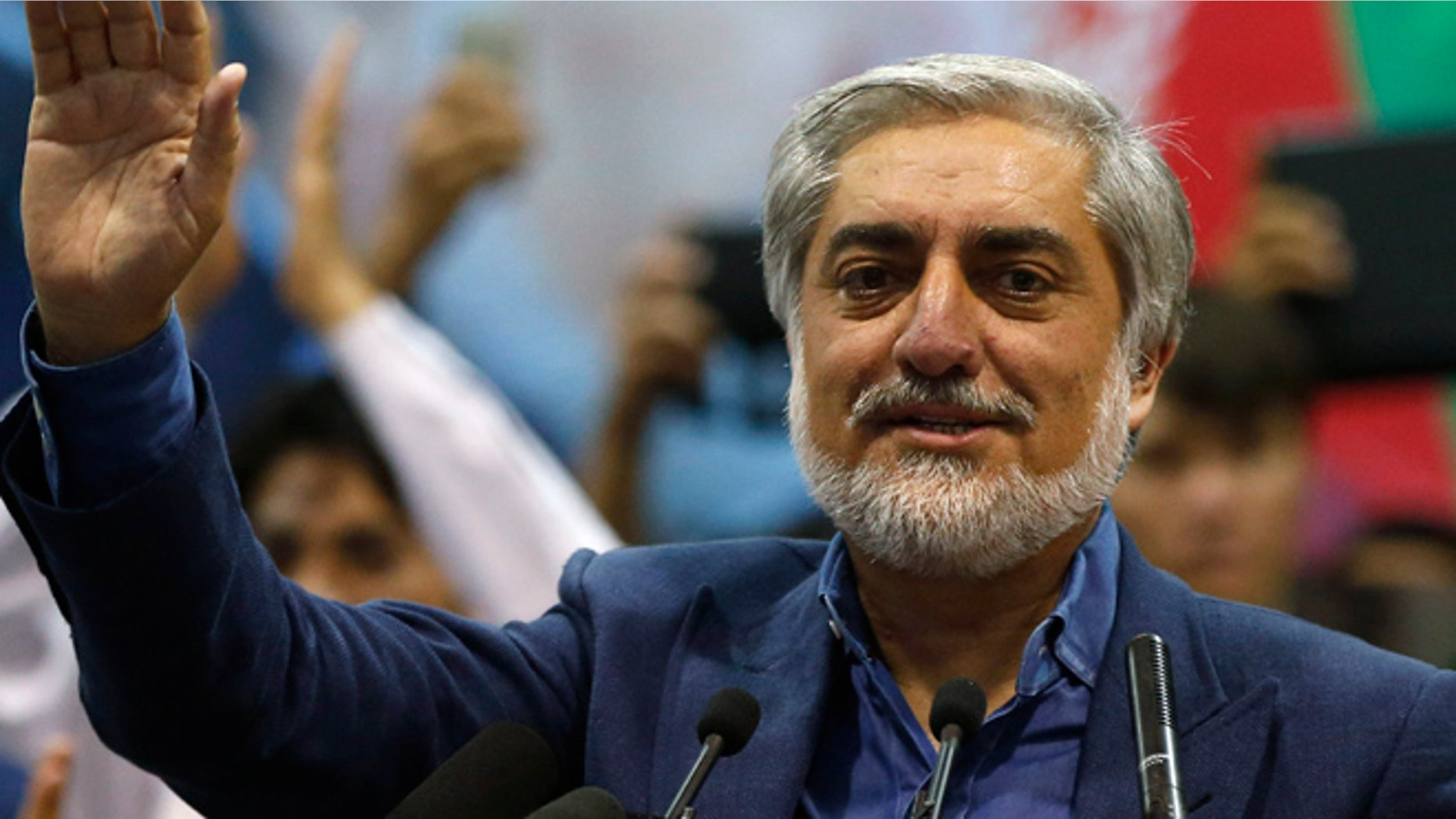 July 8: Afghan presidential candidate Abdullah Abdullah waves to his supporters during a gathering in Kabul. Abdullah told thousands of supporters on Tuesday he was the winner of last month's run-off election.